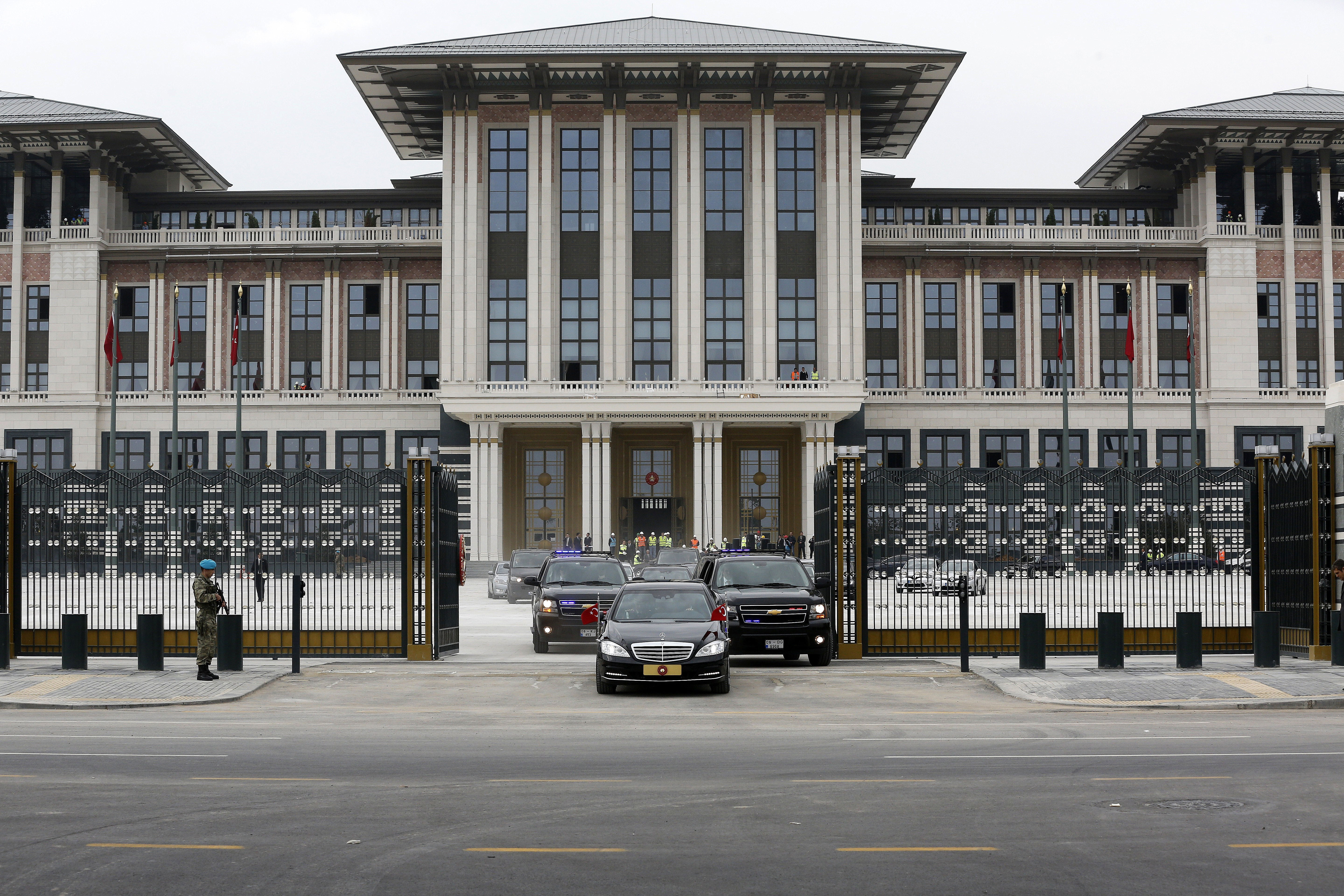 Turkish President Recep Tayyip Erdogan leaves the construction of new presidential palace built inside Ataturk Forest Farm with the official presidency car in Ankara, Turkey on Oct. 16, 2014.