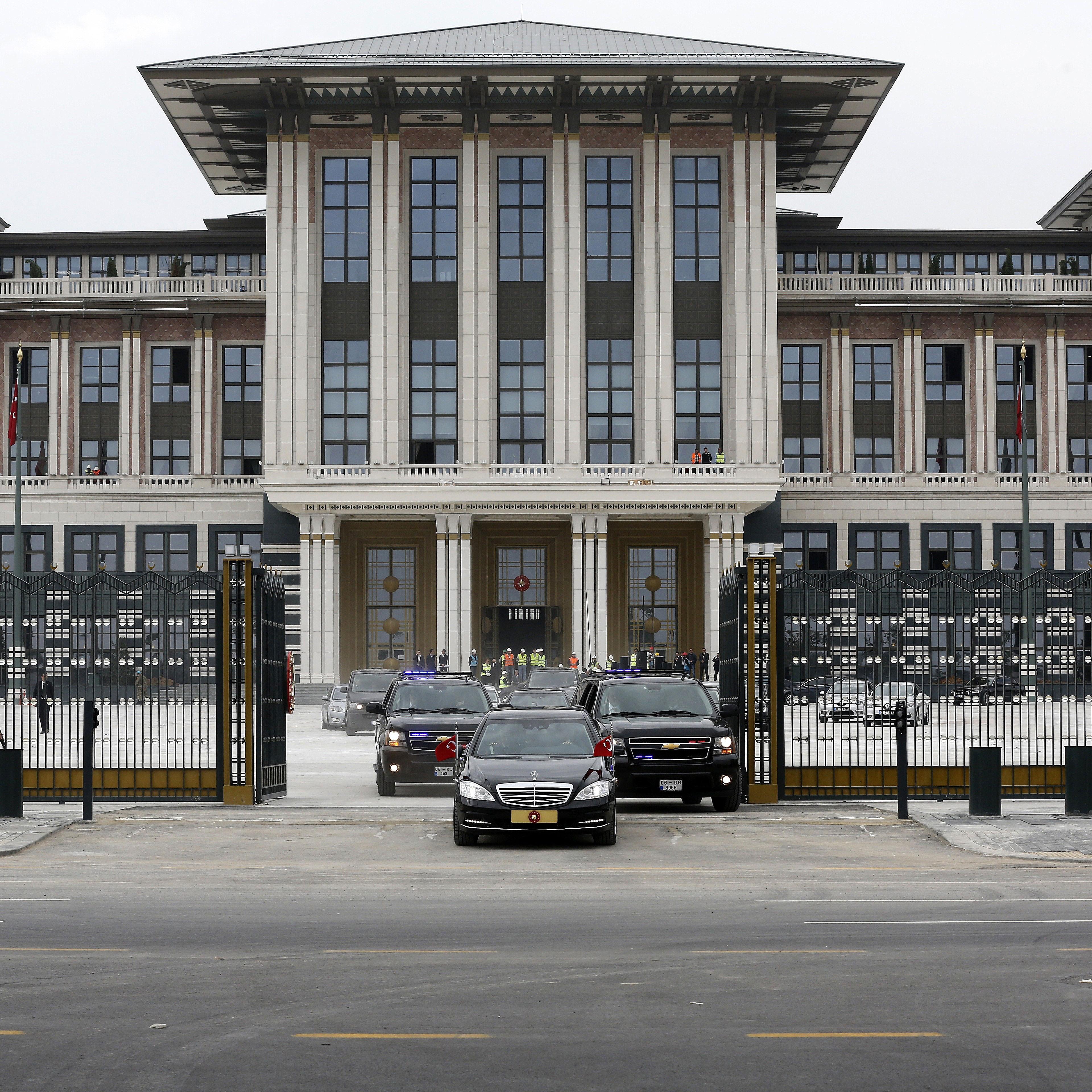 Turkish President Recep Tayyip Erdogan leaves the construction of new presidential palace built inside Ataturk Forest Farm with the official presidency car in Ankara, Turkey on Oct. 16, 2014.