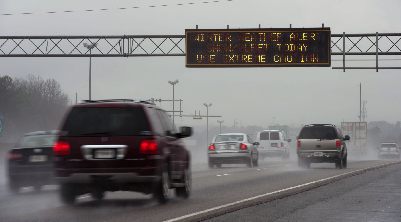Travel advisory signs along I-85 South warn drivers of upcoming hazardous driving conditions on February 11, 2014 in Atlanta.