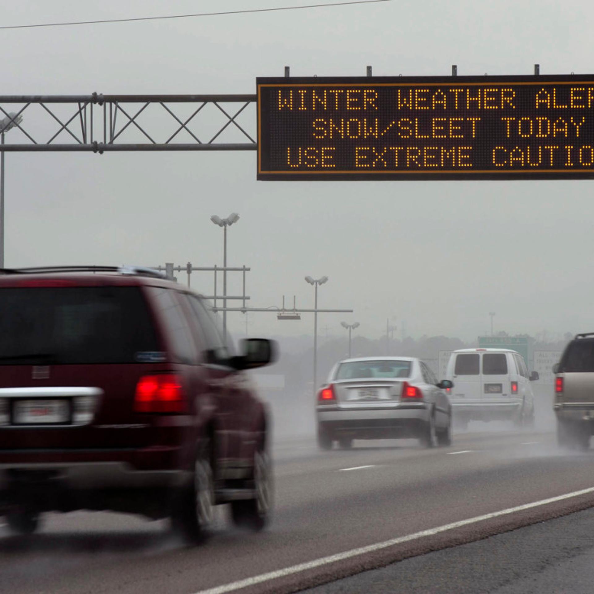 Travel advisory signs along I-85 South warn drivers of upcoming hazardous driving conditions on February 11, 2014 in Atlanta.