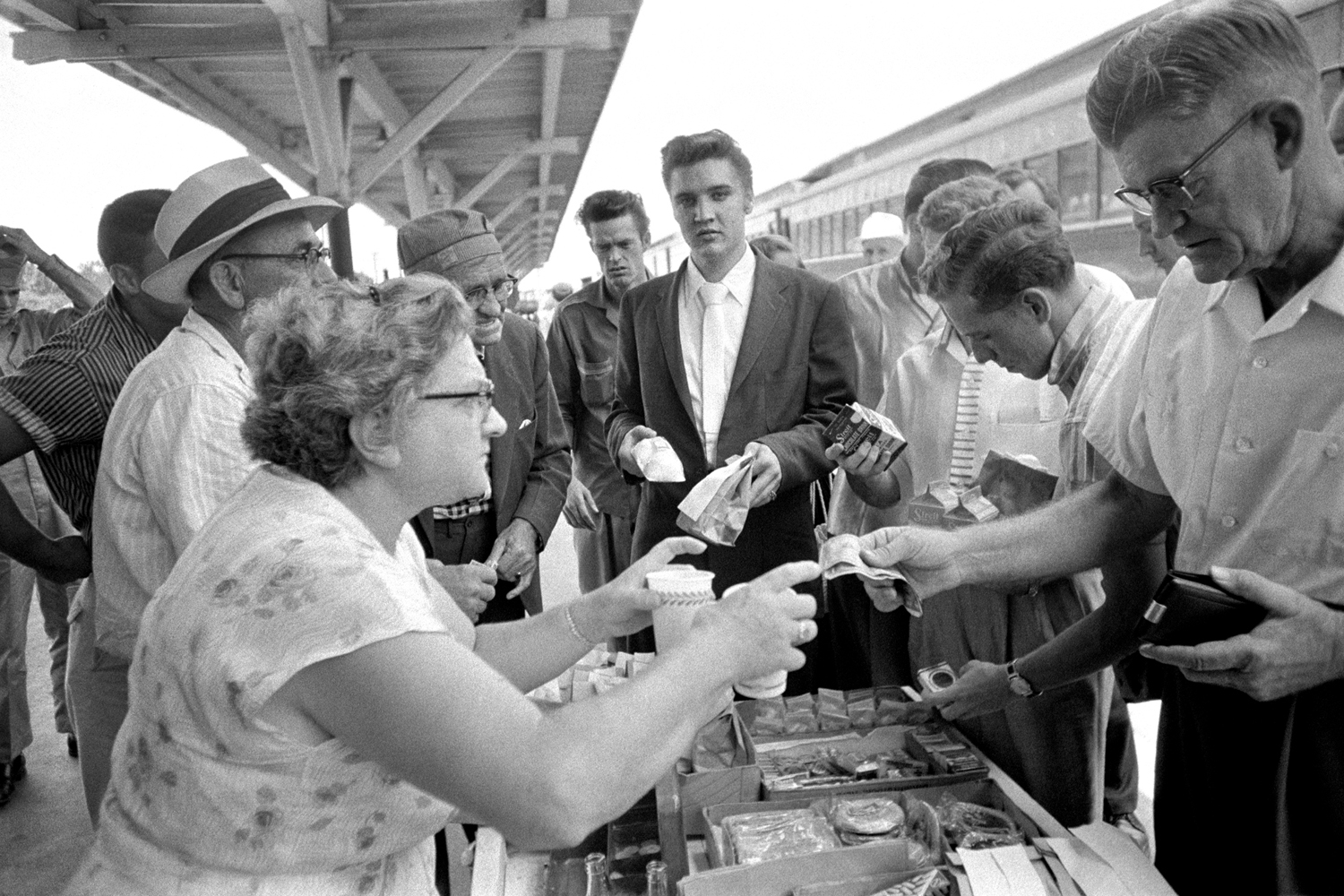 July 4, 1956. Lunchtime in Sheffield, Alabama. He’s got his snowcones and chicken wings…and his chocolate milk. Elvis never paid for anything, because he never knew where his money was. I was told that one time RCA gave Elvis $500 petty cash and he forgot where he put it. Elvis was too busy being Elvis — that was enough for him. 
