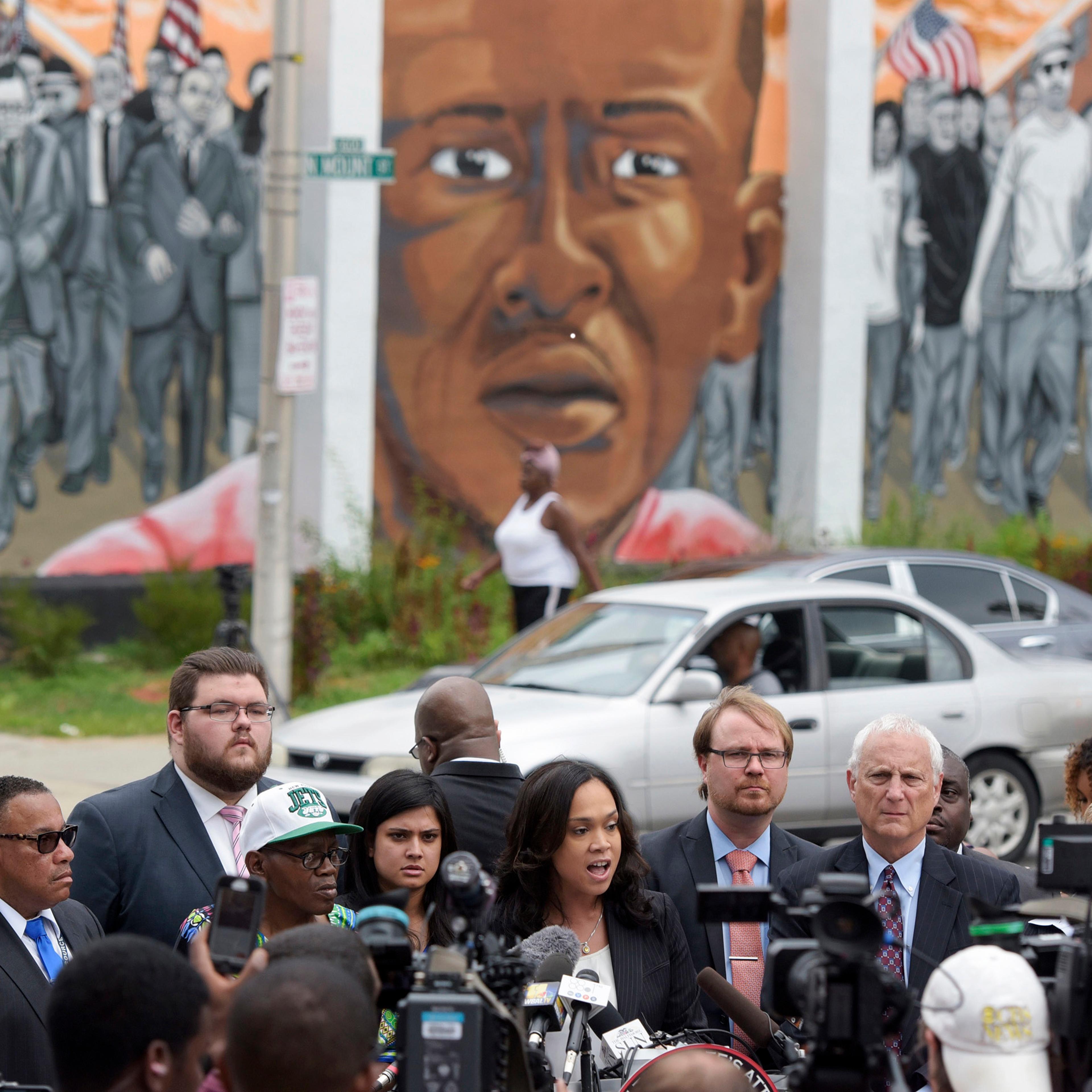 Baltimore State's Attorney Marilyn Mosby, center, speaks during a news conference after her office dropped remaining charges against the three Baltimore police officers who were still awaiting trial in Freddie Gray’ death, in Baltimore on July 27, 2016.