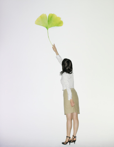 businesswoman-reaching-leaf