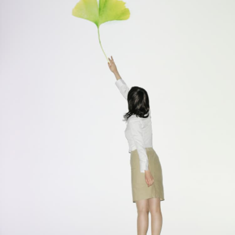 businesswoman-reaching-leaf