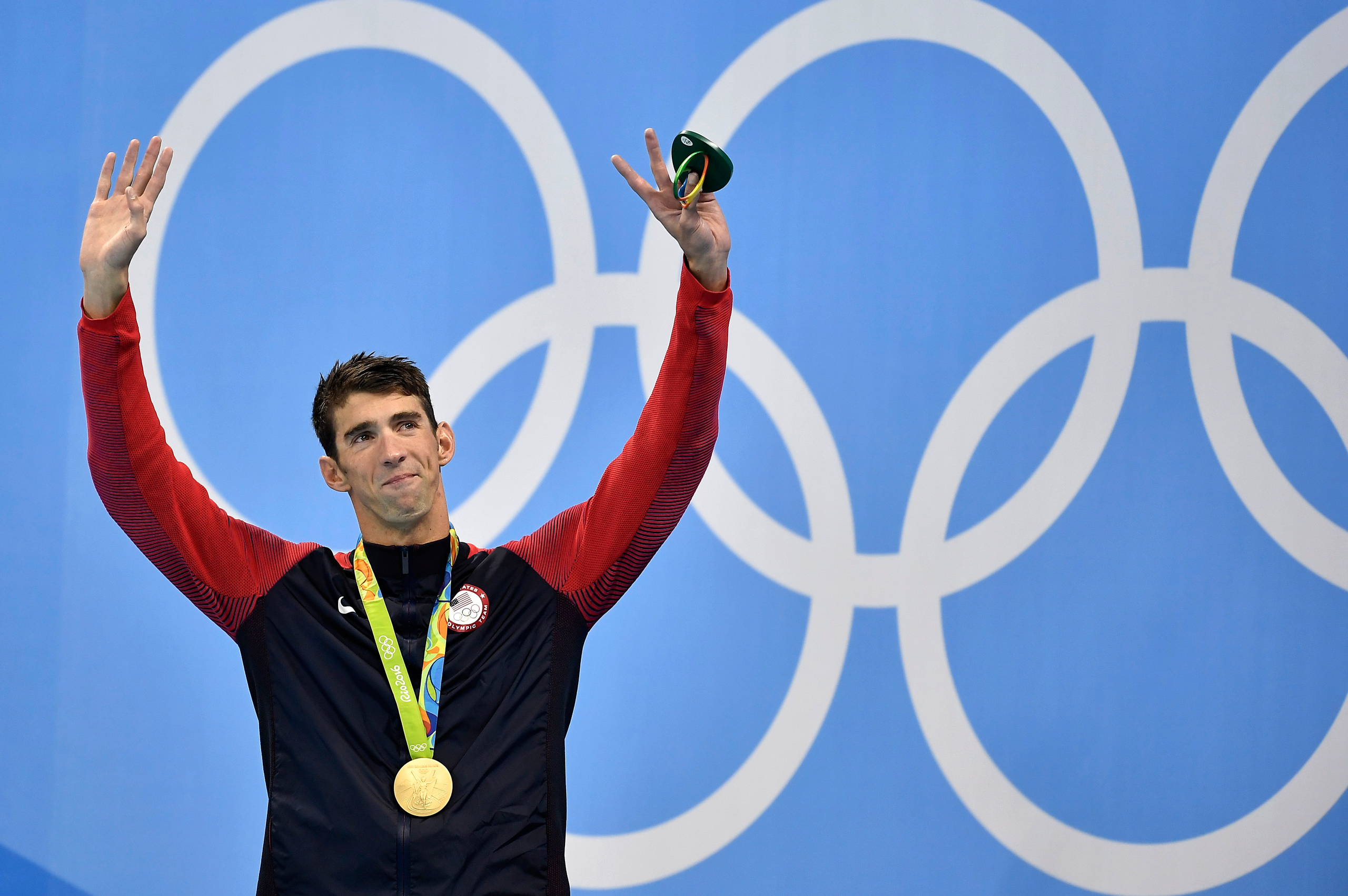 United States' Michael Phelps celebrates after he was awarded the gold medal during the medal ceremony for the men's 200-meter individual medley final during the swimming competitions at the 2016 Summer Olympics, Thursday, Aug. 11, 2016, in Rio de Janeir