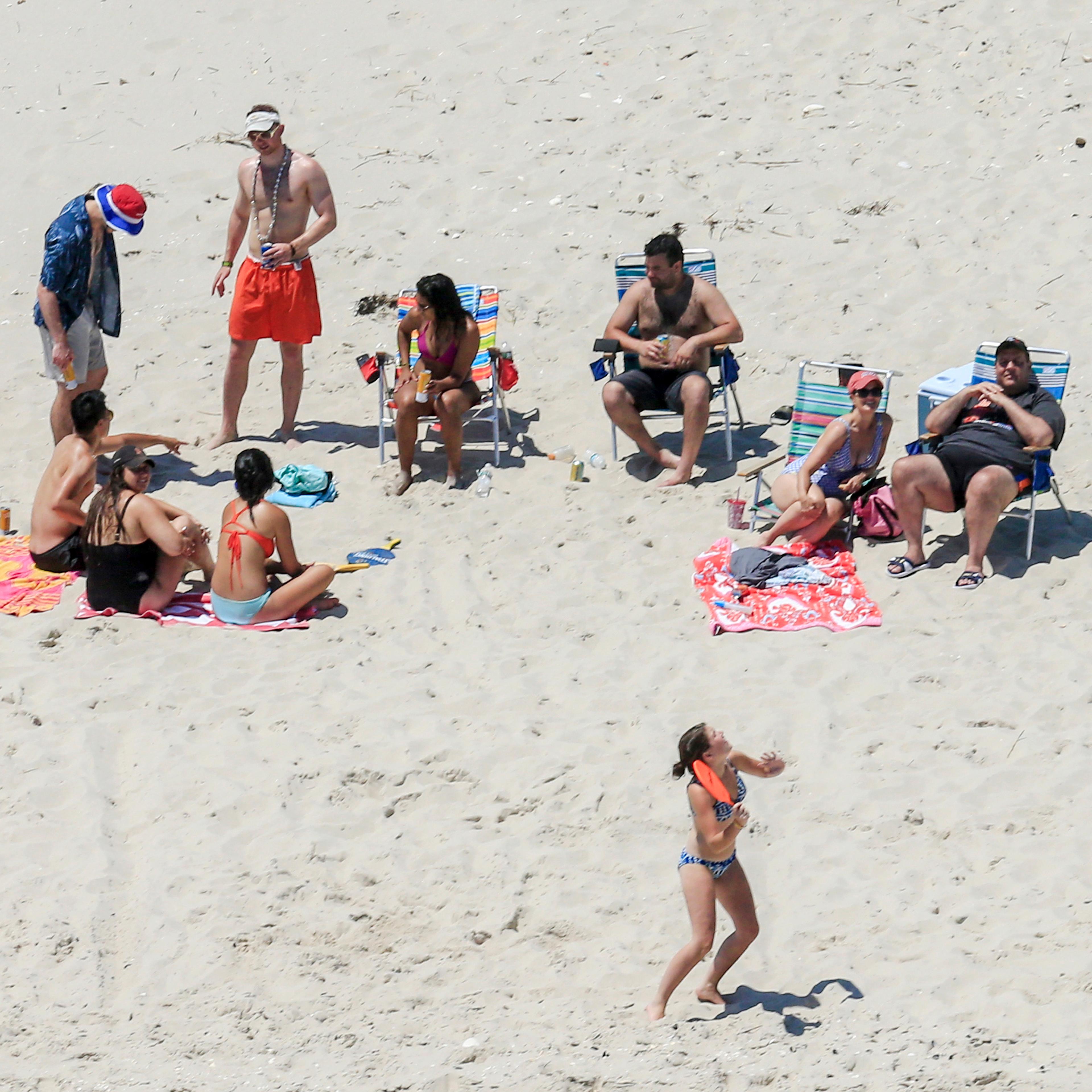 New Jersey Gov. Chris Christie, right, uses the beach with his family and friends at the governor's summer house at Island Beach State Park in New Jersey on July 2, 2017.