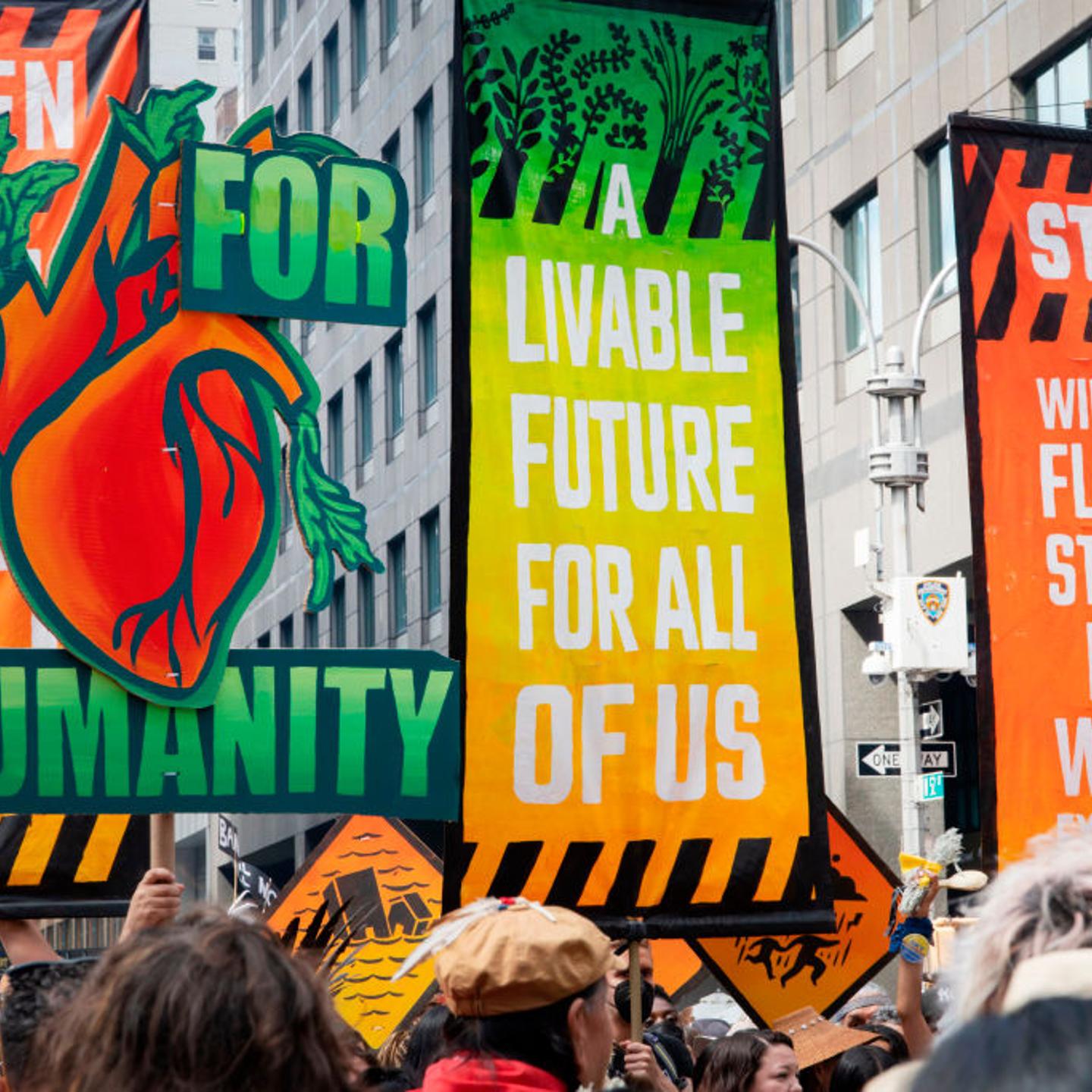 Four large banners at March to End Fossil Fuels
