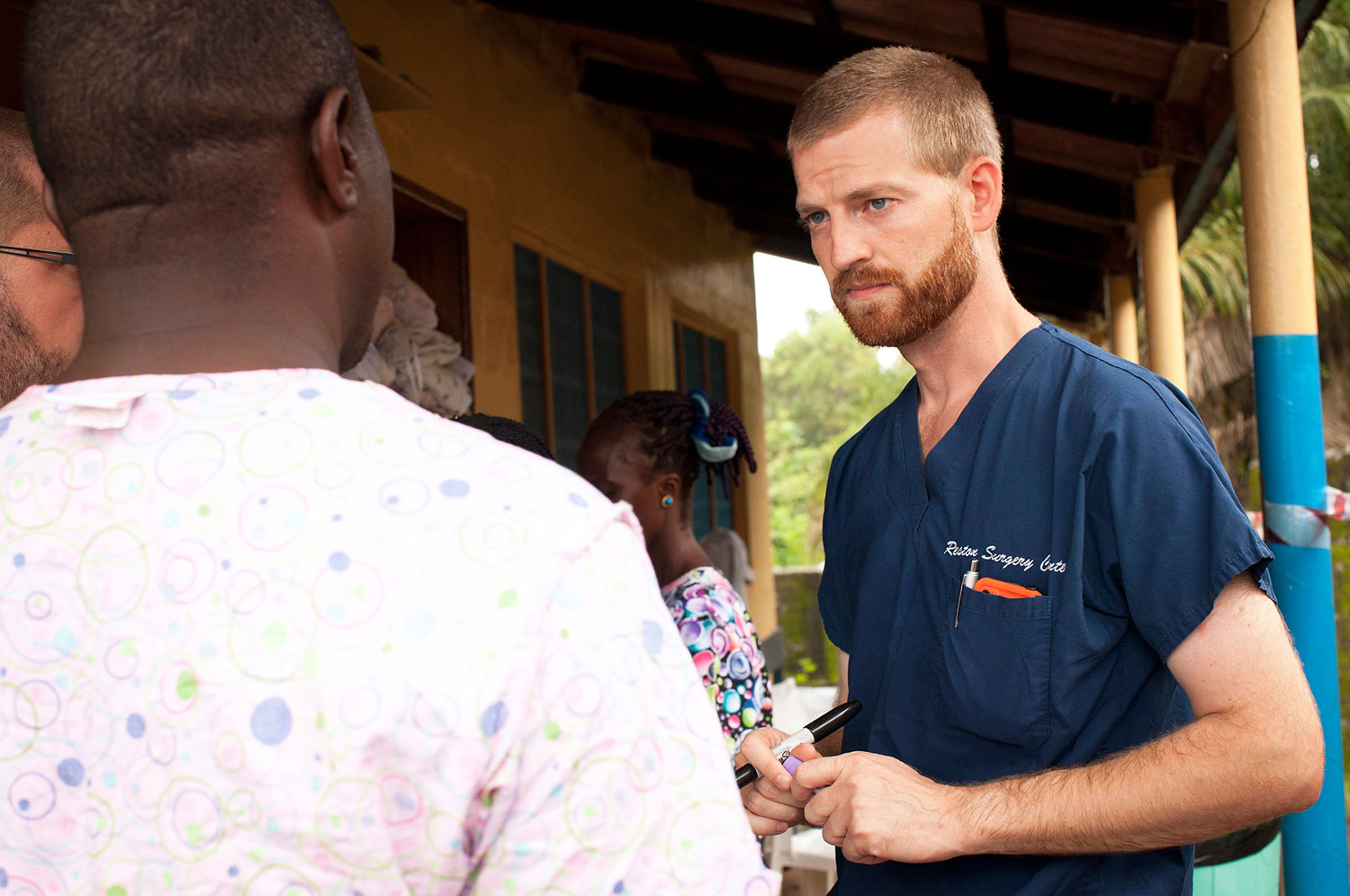 Handout photo of Dr. Kent Brantly speaking with colleagues at the case management center on the campus of ELWA Hospital in Monrovia