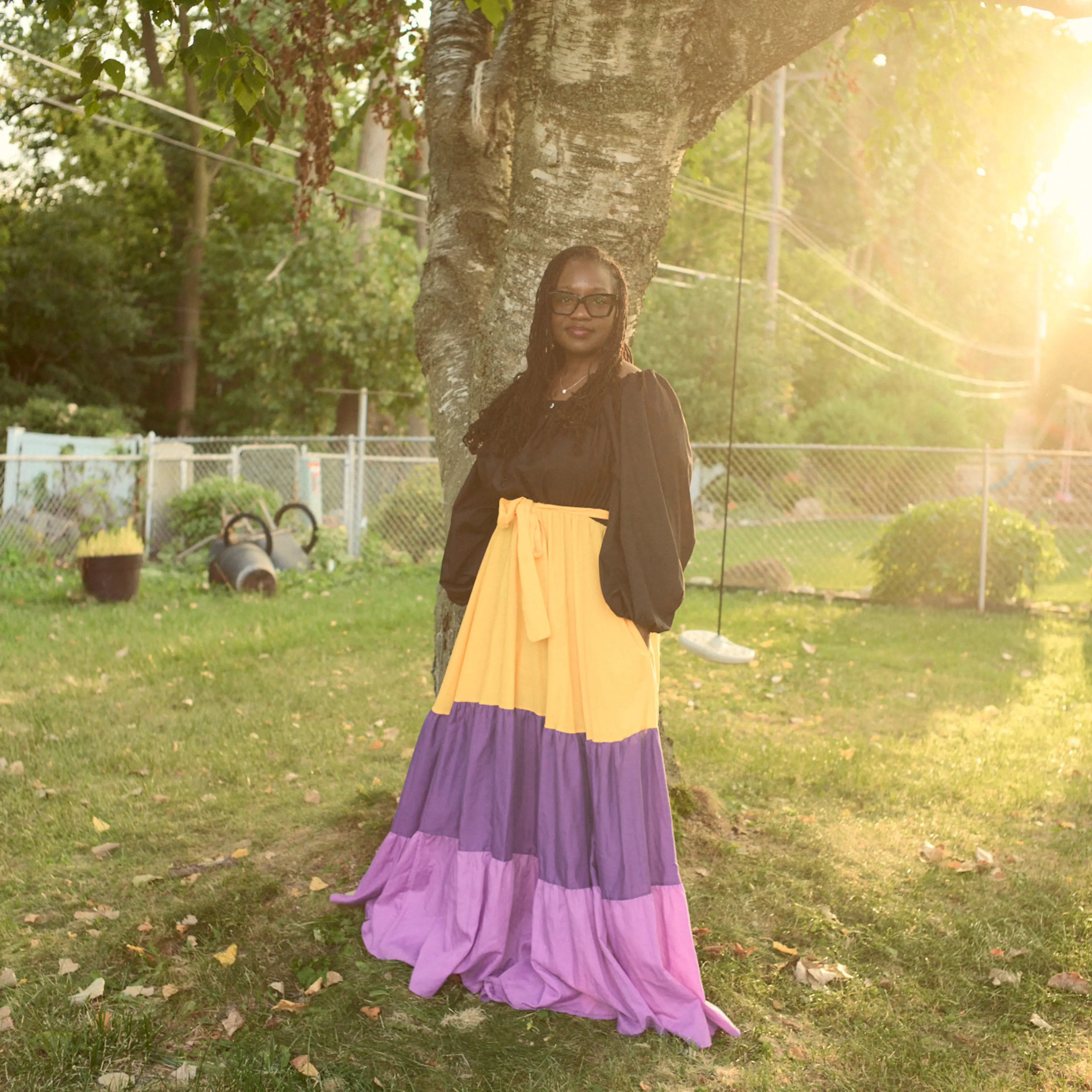 Lisa Thomas stands in her backyard in a patch of sunshine on Sept. 18, 2025 in Clinton Township, Michigan.
