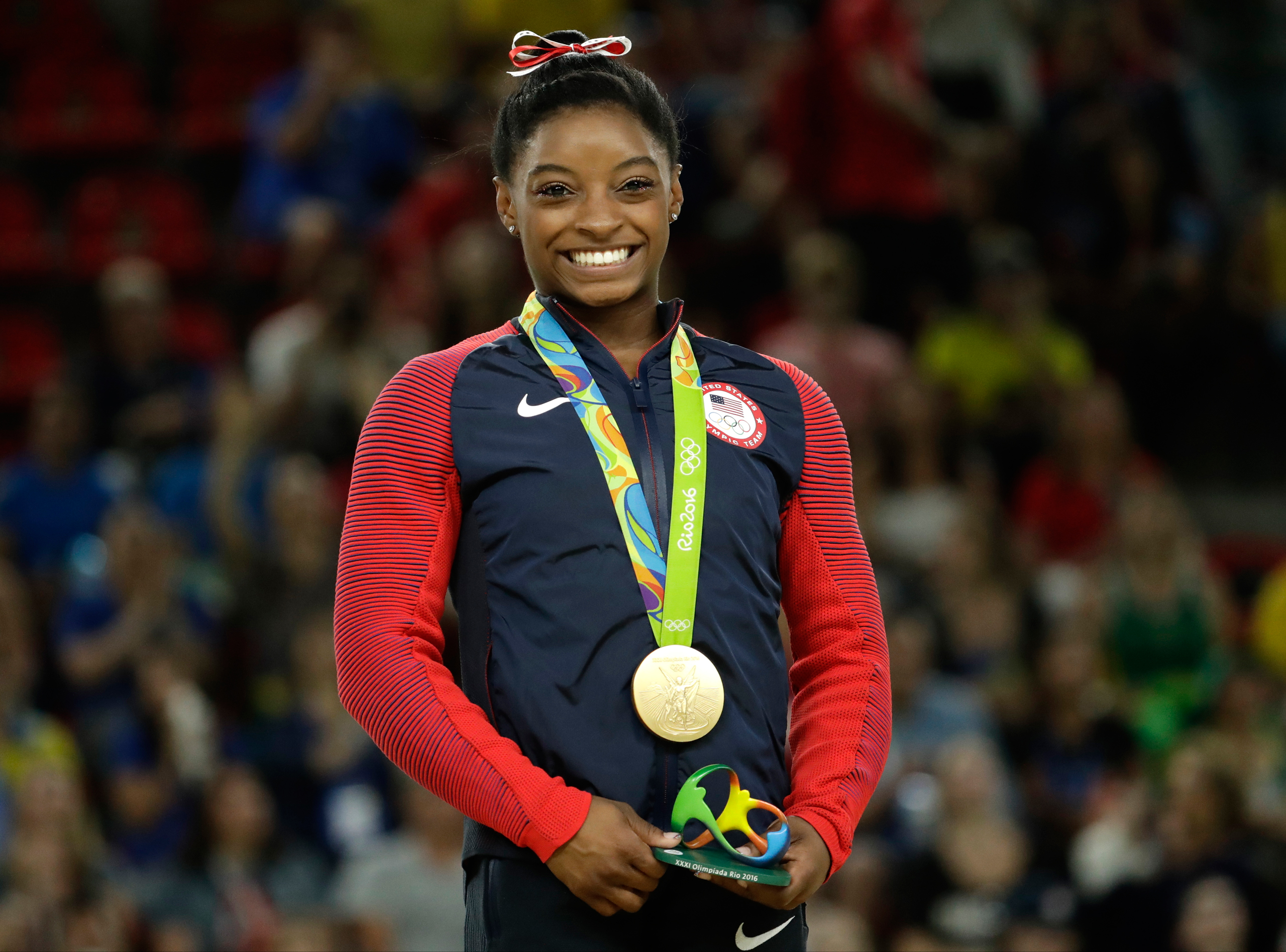 United States' Simone Biles smiles on the podium after winning vault gold during the artistic gymnastics women's apparatus final at the 2016 Summer Olympics in Rio de Janeiro, Brazil, Sunday, Aug. 14, 2016. (AP Photo/Dmitri Lovetsky)