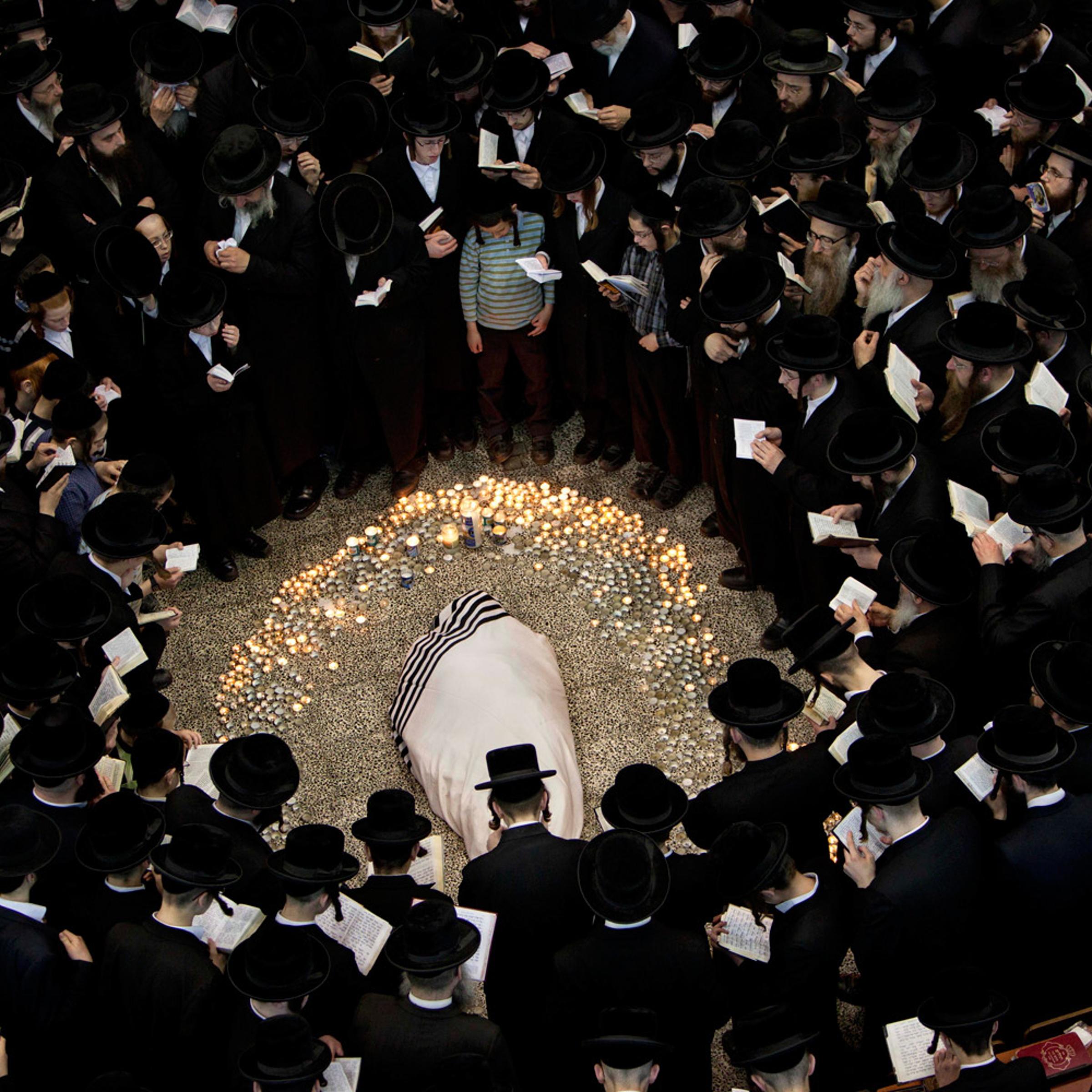 March 14, 2012. Ultra-Orthodox Jews gather around the body of Rabbi Moshe Yehoshua Hager, leader of the~Hassidic sect Vizhnitz in Israel, at the Vizhnitz Synagogue during his funeral procession in Bnei Brak, Israel.