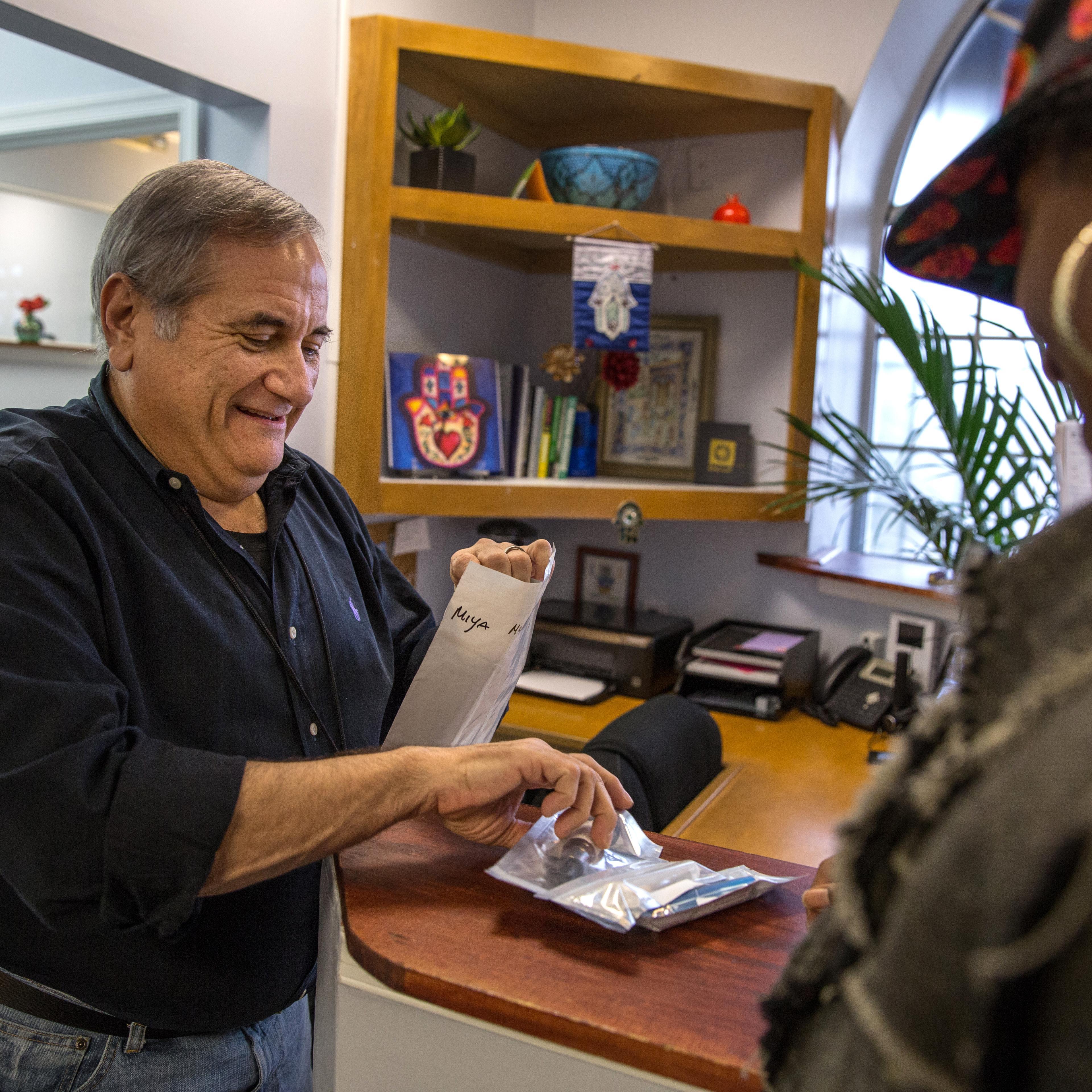 Rabbi Jeffrey Kahn, owner of the Takoma Wellness Center, dispenses medical marijuana on Oct. 10, 2014, in Takoma Park, DC.