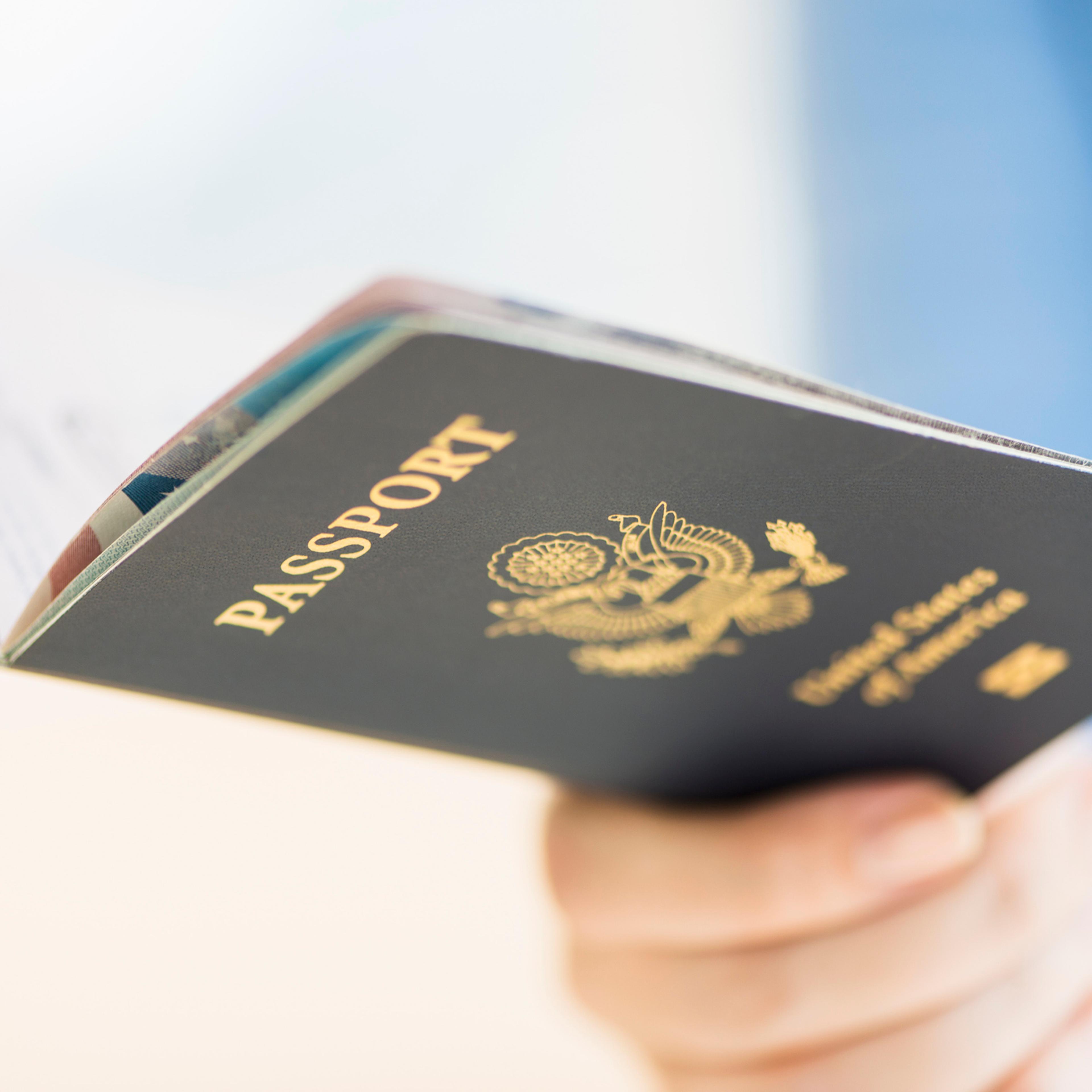 USA, New Jersey, Jersey City, Close up of woman's hand holding open passport
