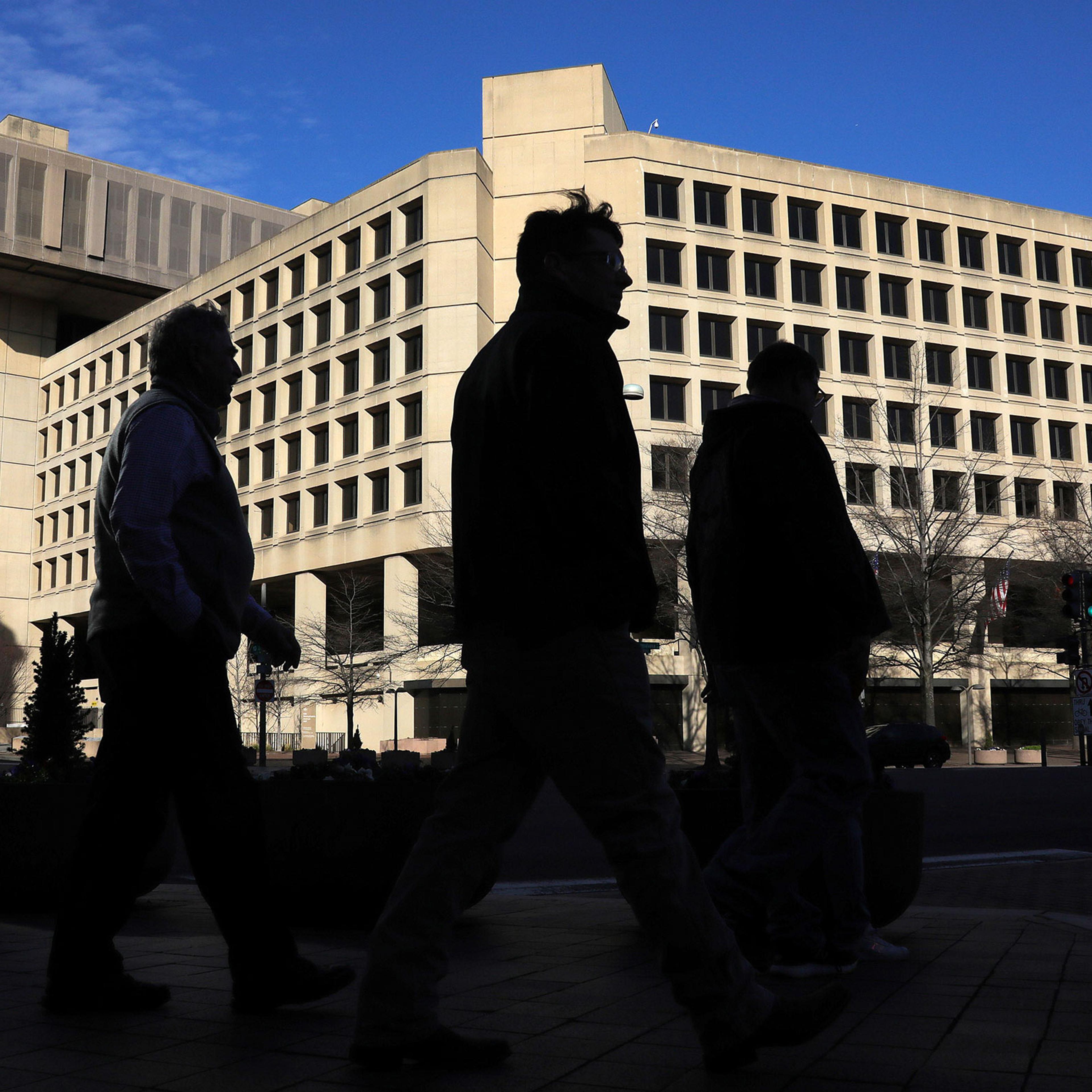 People walking by the FBI Headquarters in Washington