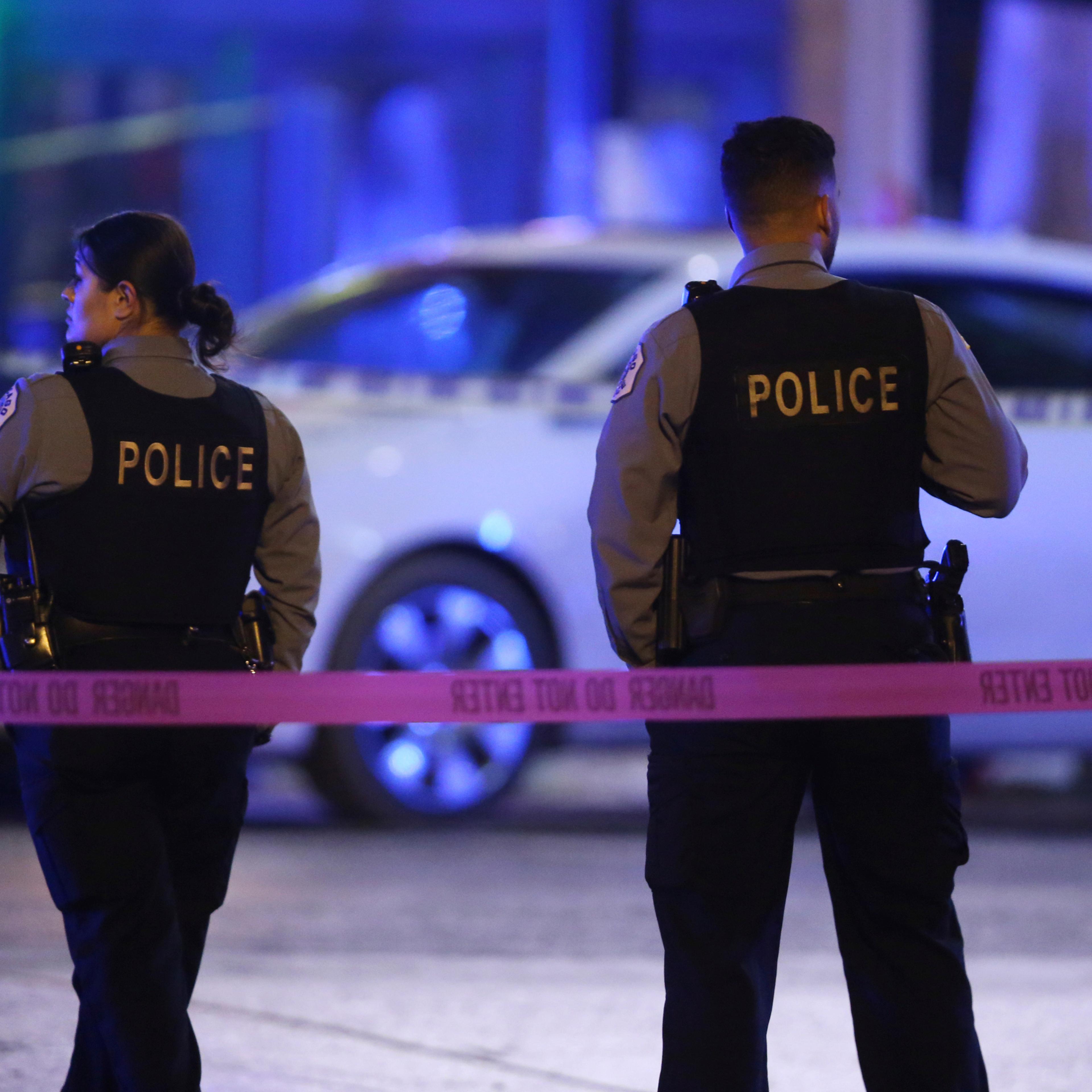 Police work the scene at North Lowell Ave and West Irving Park Road in Chicago