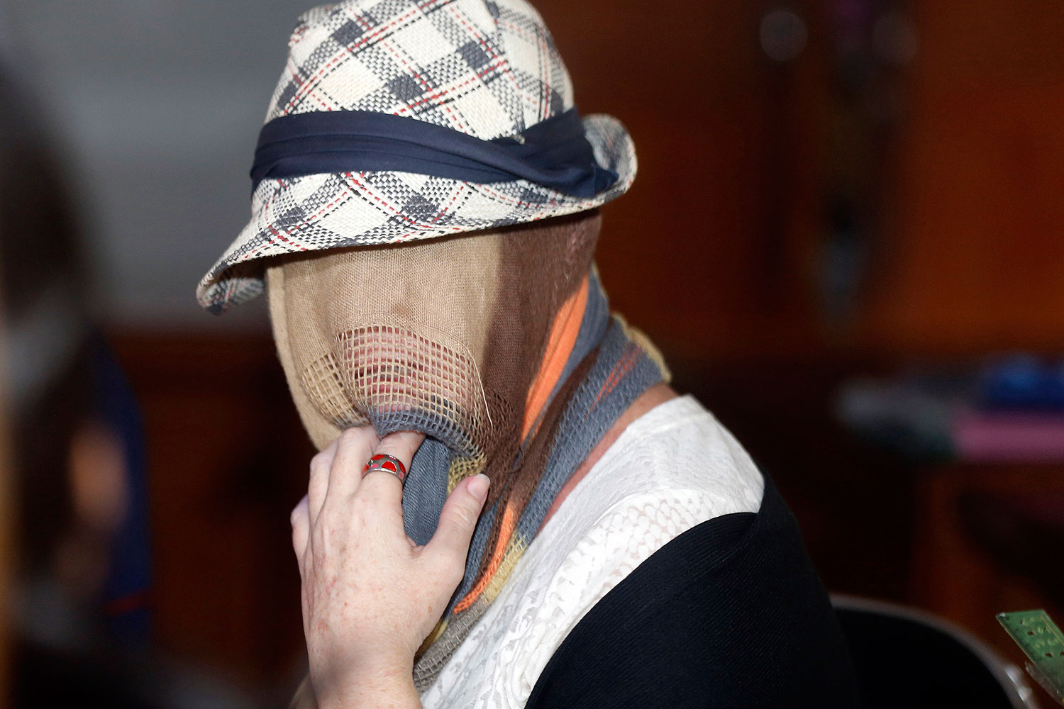 Convicted Australian drug trafficker Schapelle Corby. with her head covered, sits in the Denpasar Parole Board Office following her release from Kerobokan Prison in Bali on Feb. 10, 2014