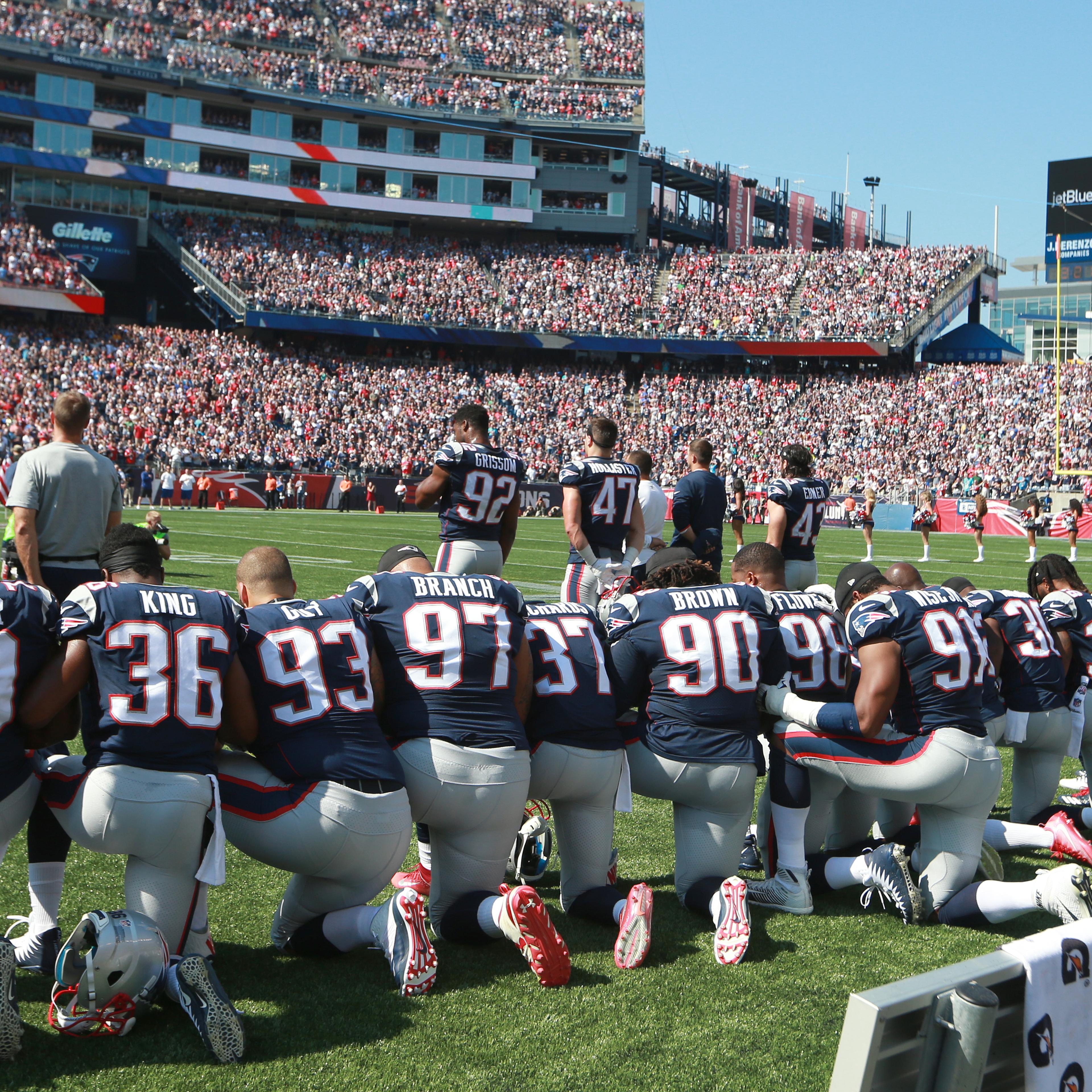 New England Patriots players take a knee during the national anthem before the start of a game against the Houston Texans at Gillette Stadium in Foxborough, Mass., Sept. 24, 2017.