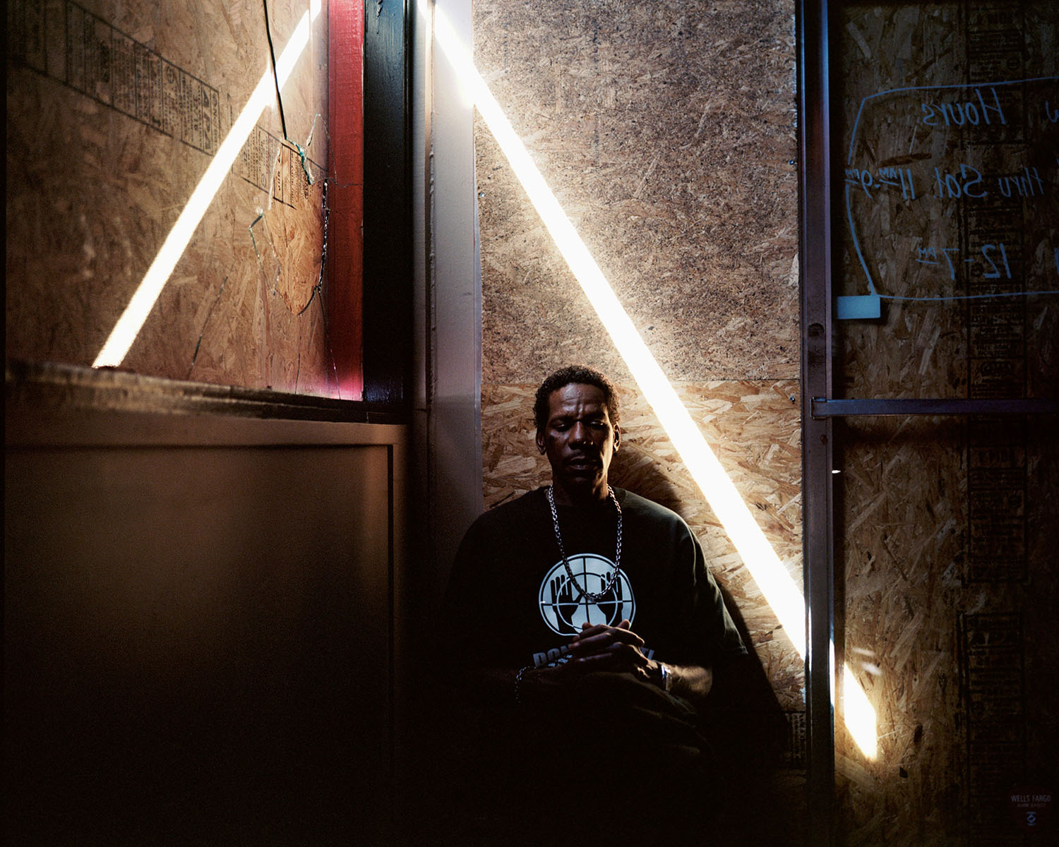 Steven Nelson, 51, sits where a window was broken at Red's Original BBQ where he works in Ferguson, Missouri on October 8, 2014.