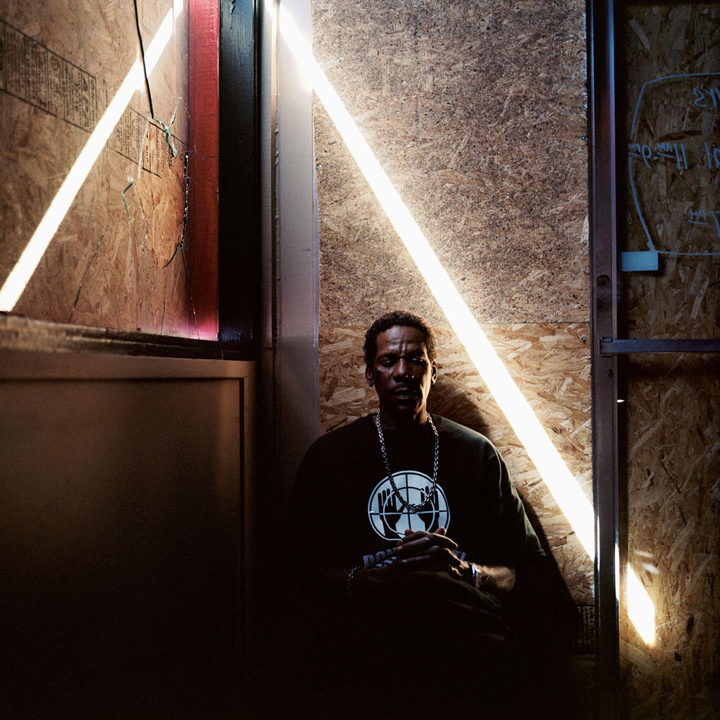 Steven Nelson, 51, sits where a window was broken at Red's Original BBQ where he works in Ferguson, Missouri on October 8, 2014.