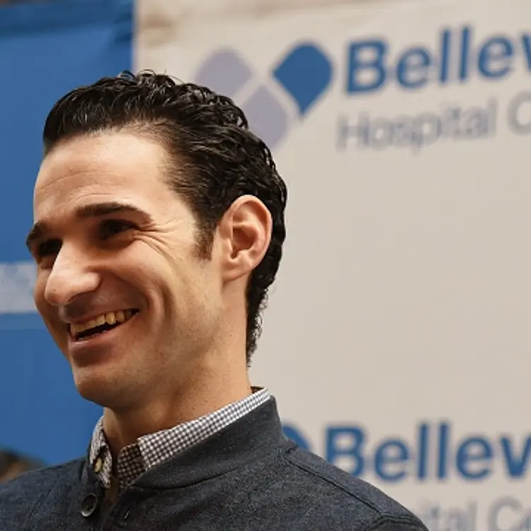 Dr. Craig Spencer smiles during a news conference November 11, 2014 at Bellevue Hospital in New York.