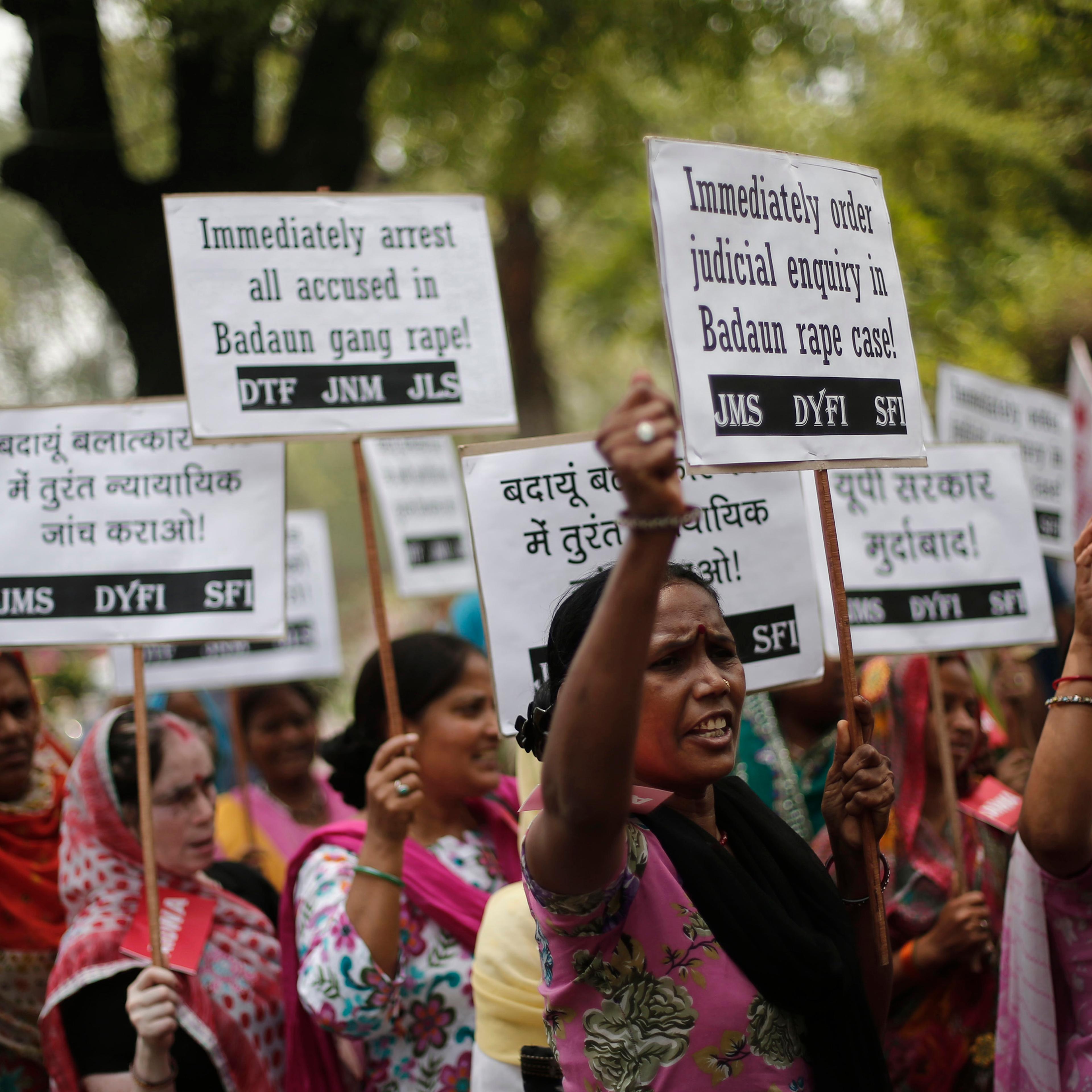 Demonstrators from AIDWA hold placards and shout slogans during protest against recent killings of two teenage girls, in New Delhi