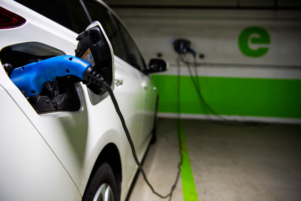 A Toyota Prius is seen connected to a electric vehicle charging station in a Washington, D.C., parking garage on March 31, 2021.