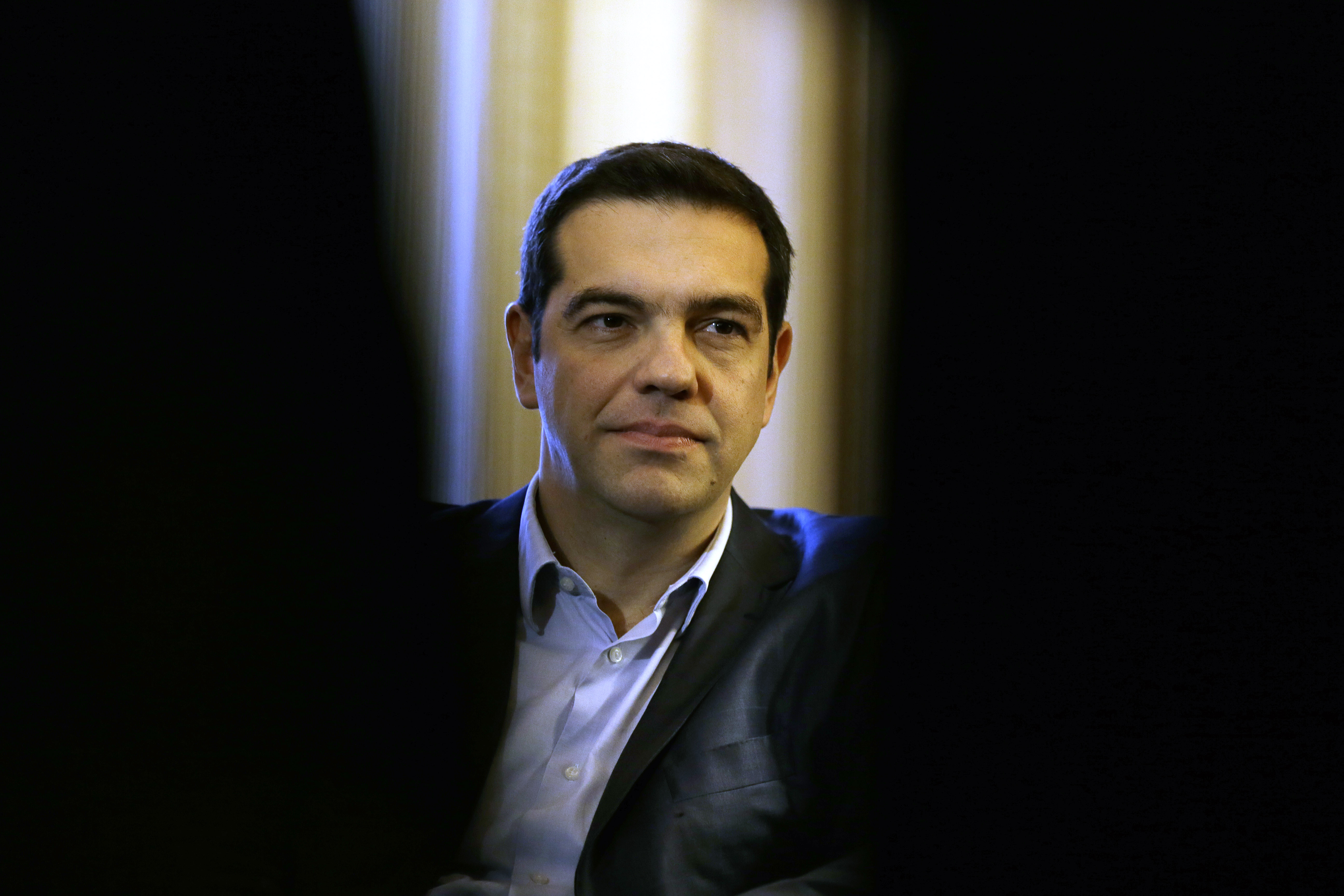 Greece Prime Minister Alexis Tsipras listens to Greek President Karolos Papoulias during their meeting at Presidential Palace in Athens, Greece on Feb. 18, 2015.