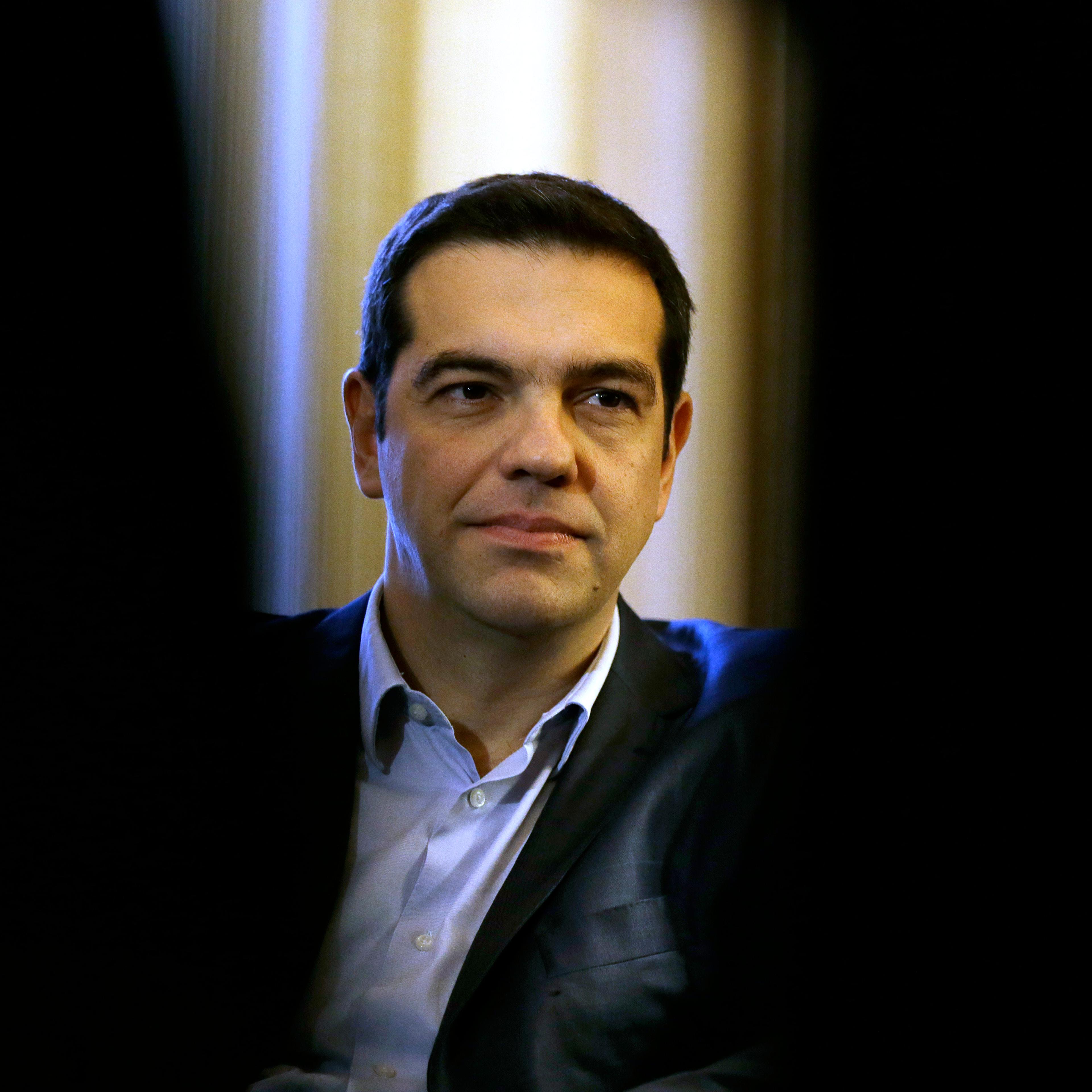 Greece Prime Minister Alexis Tsipras listens to Greek President Karolos Papoulias during their meeting at Presidential Palace in Athens, Greece on Feb. 18, 2015.