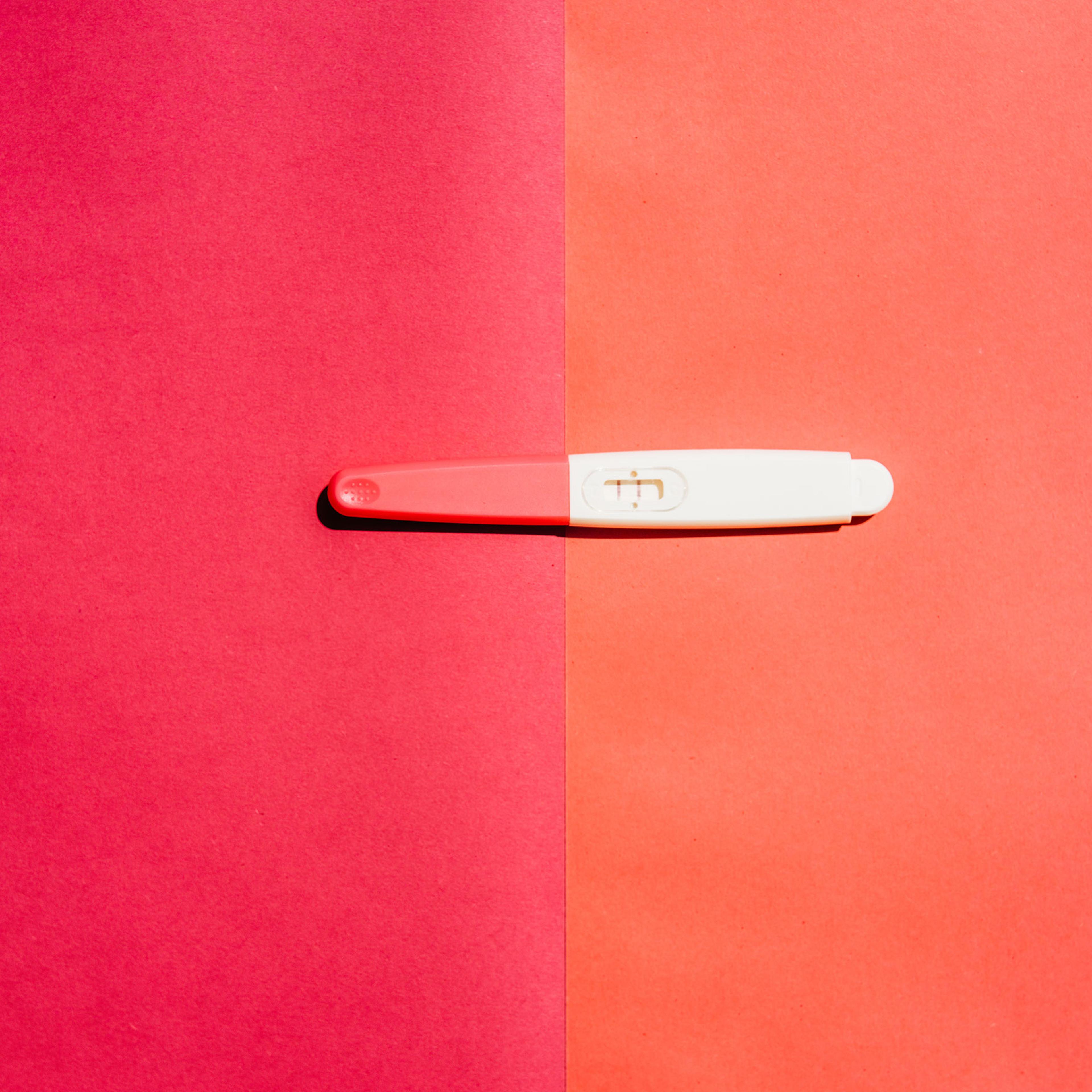 Pregnancy test on pink background.