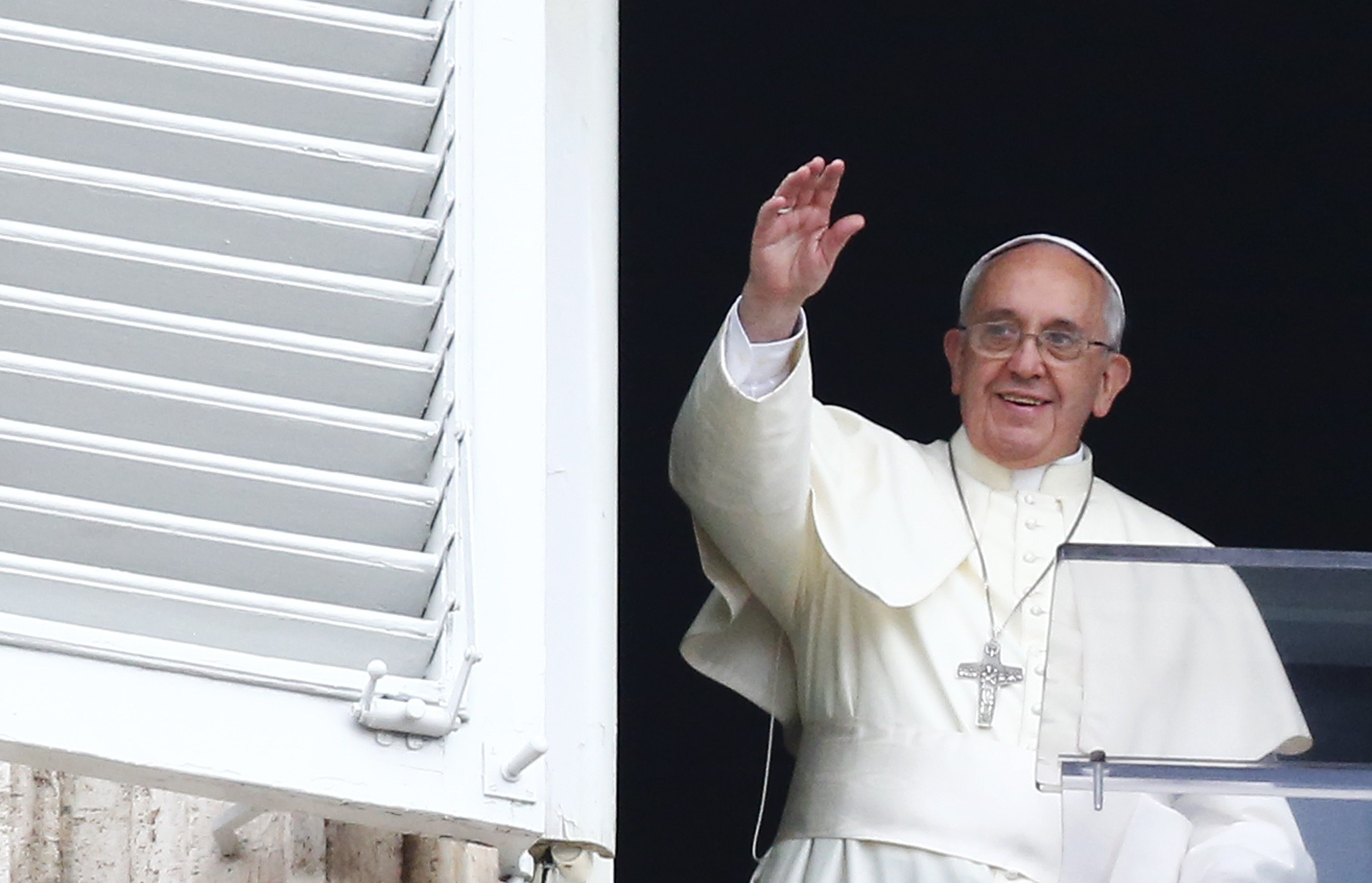 Pope Francis waves as he leads his Sunday Angelus prayer in Saint Peter's square at the Vatican on July 13, 2014.