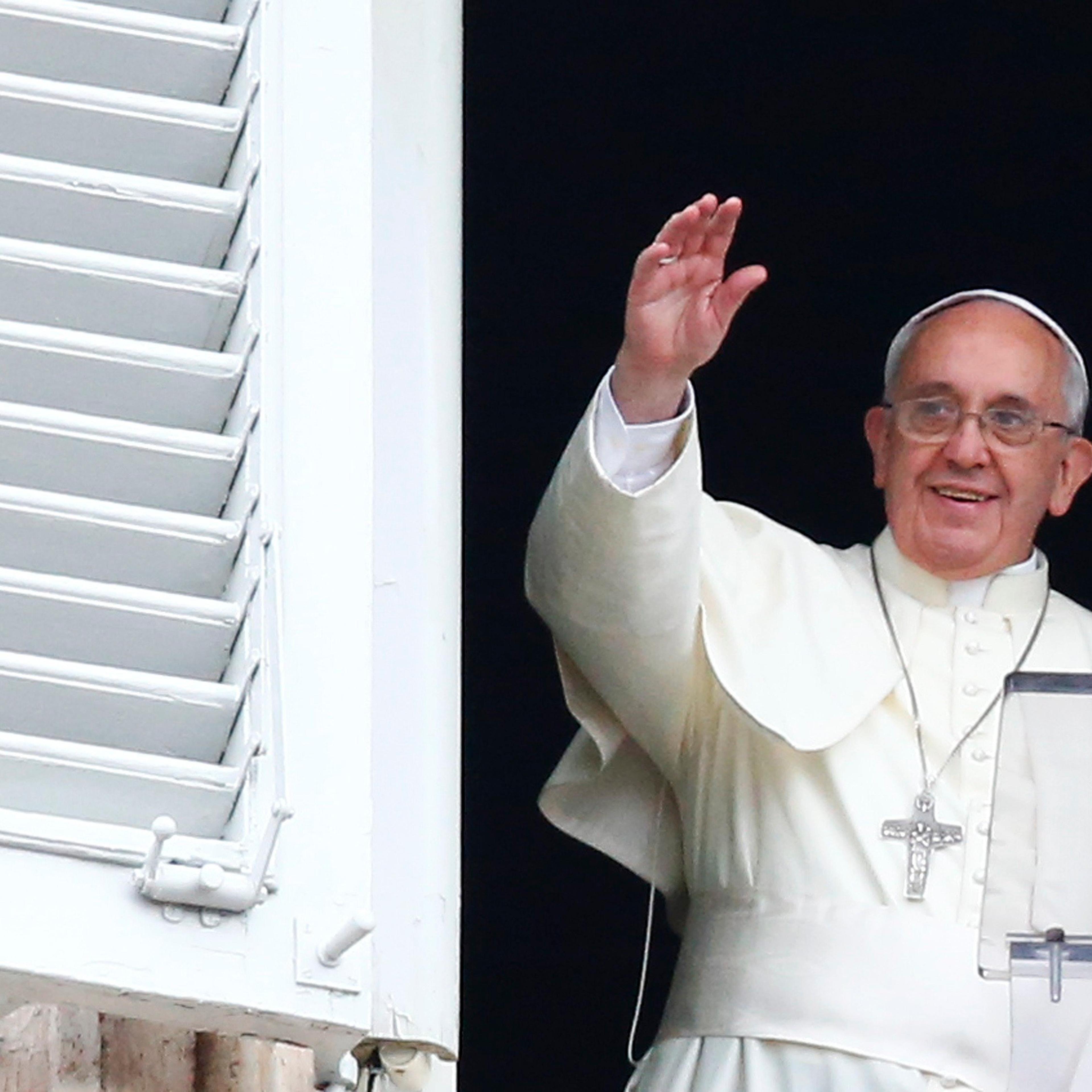 Pope Francis waves as he leads his Sunday Angelus prayer in Saint Peter's square at the Vatican on July 13, 2014.
