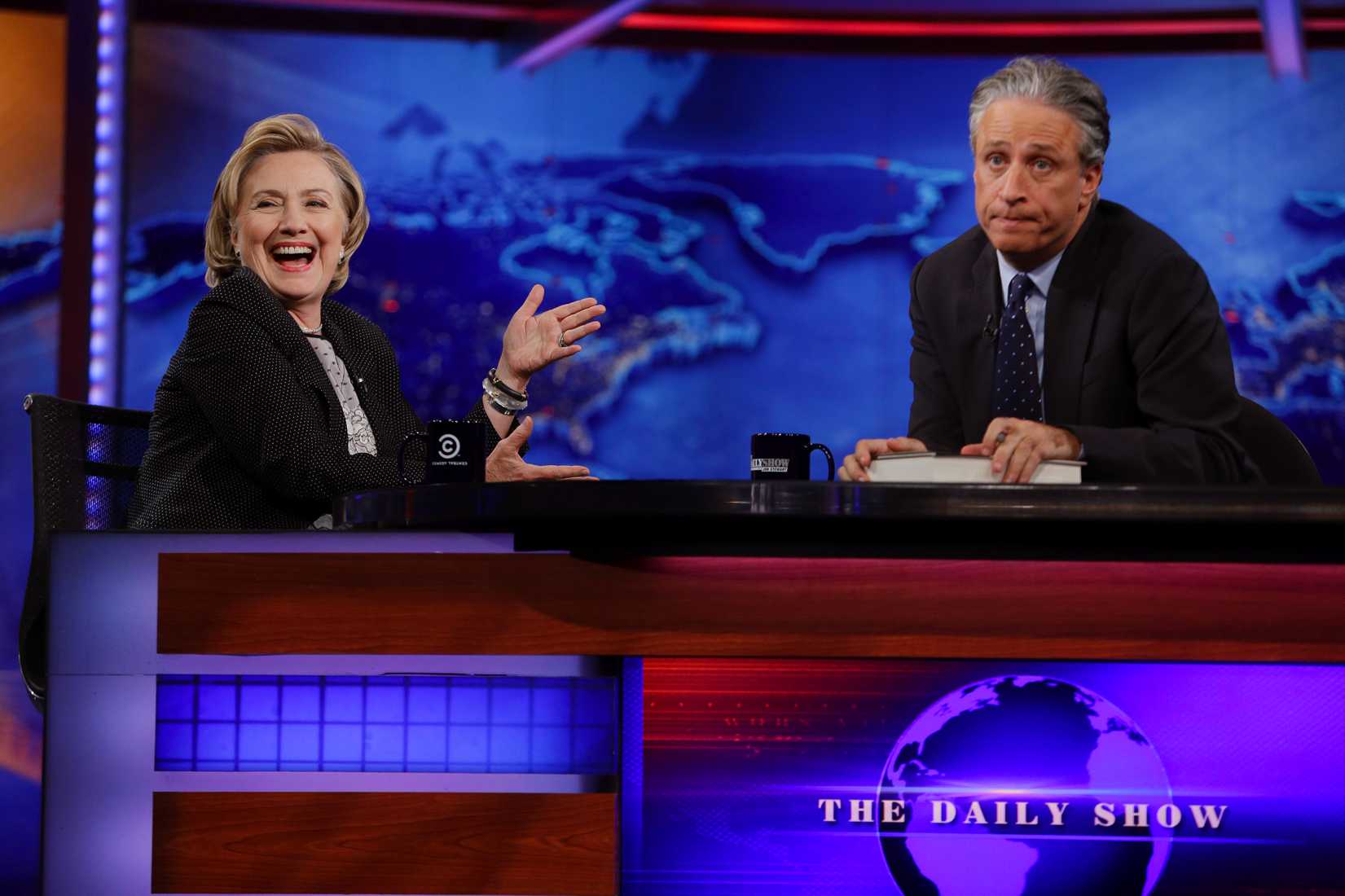 Former U.S. Secretary of State Hillary Clinton listens to host Jon Stewart during a taping of <i>The Daily Show</i>, Tuesday, July 15, 2014, in New York City.