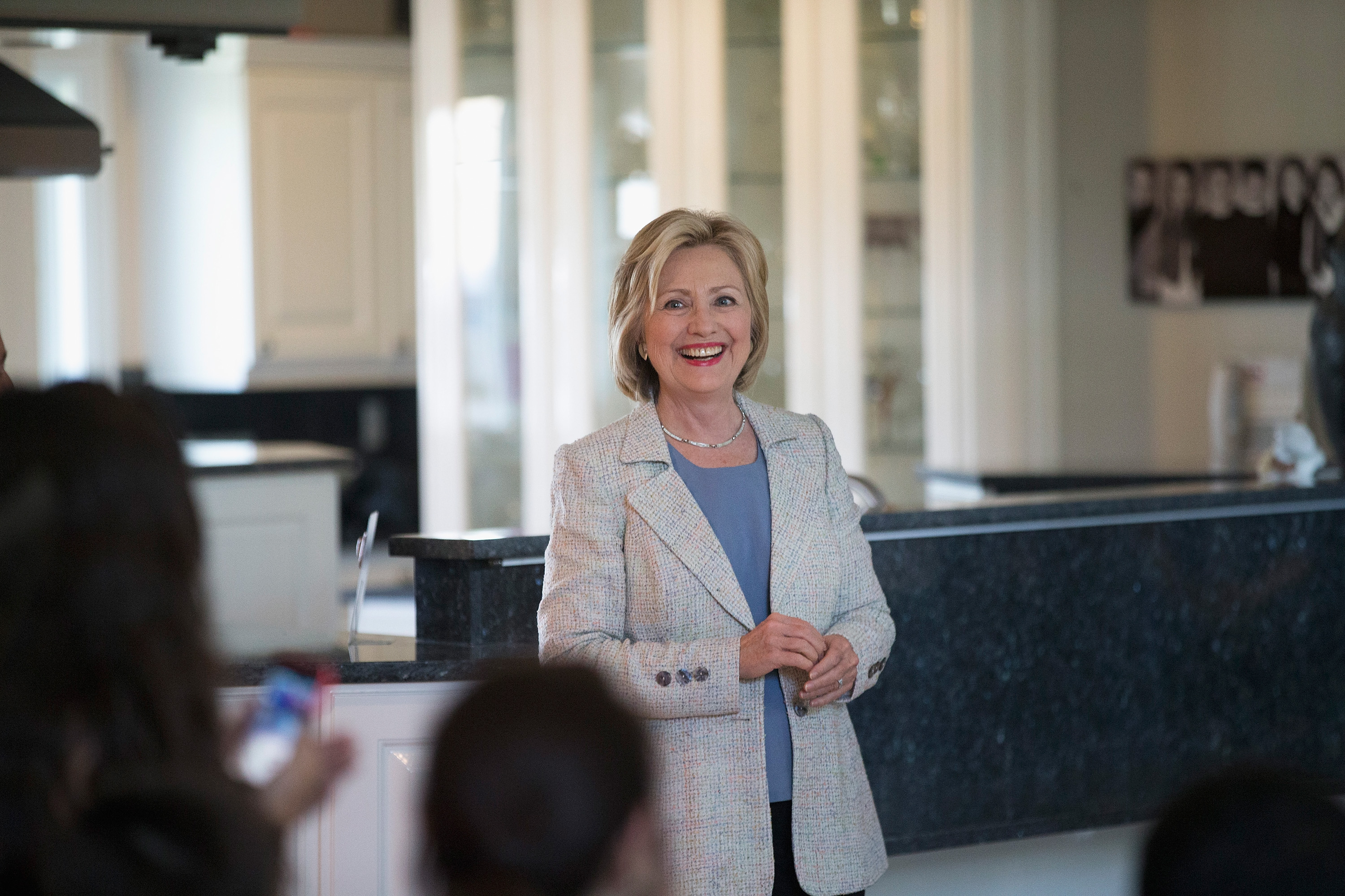 Democratic presidential hopeful and former Secretary of State Hillary Clinton waits to be introduced at a house party on July 26, 2015 in Carroll, Iowa.