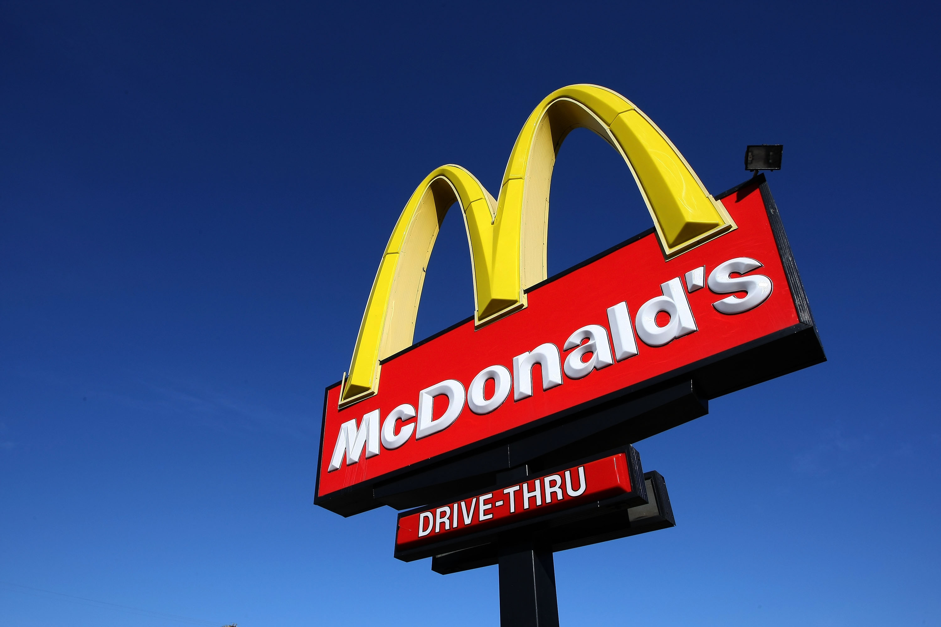 A sign stands outside of a McDonald's restaurant in San Francisco.