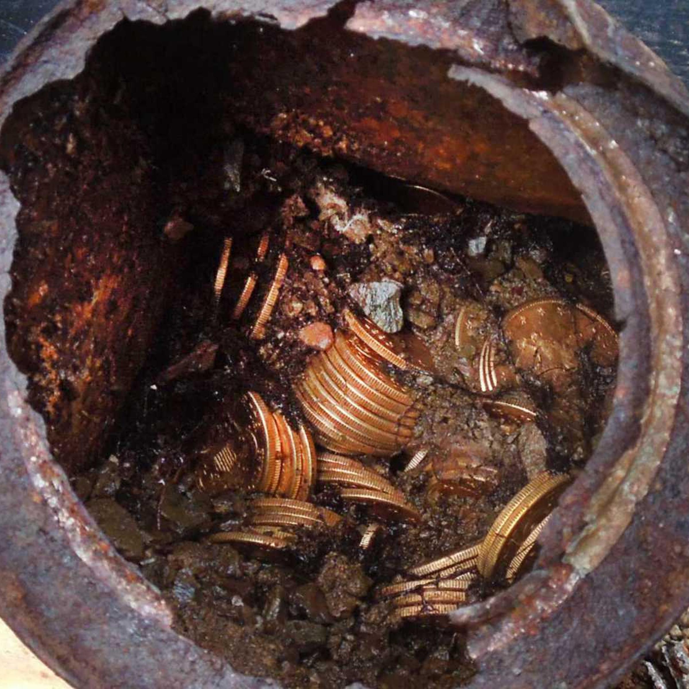 This image provided by the Saddle Ridge Hoard discoverers via Kagin's, Inc., shows one of the six decaying metal canisters filled with 1800s-era U.S. gold coins unearthed in California by two people who want to remain anonymous.
