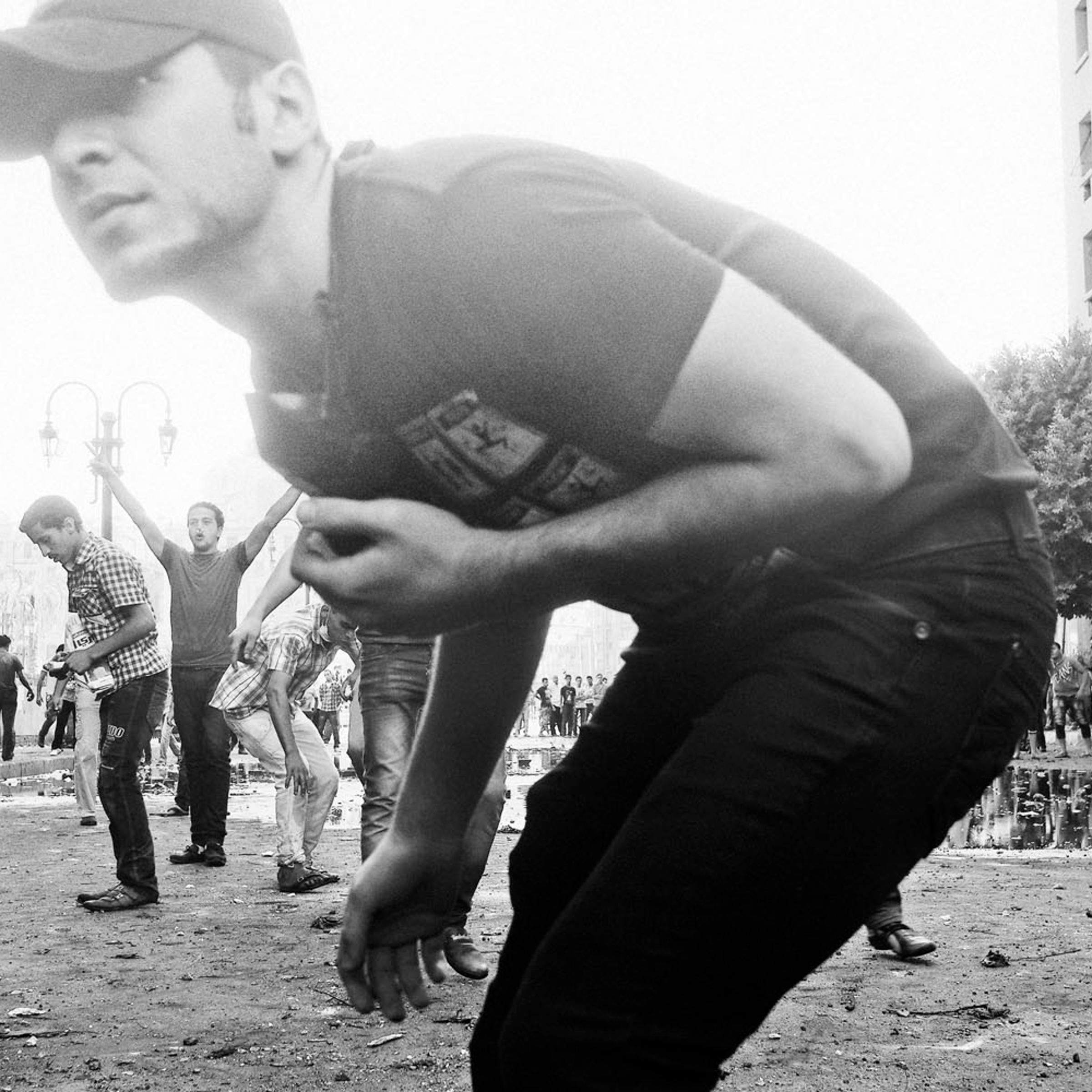 <i>The following photographs were taken on Sept. 13-14, 2012.</i><br />
Protestors throw rocks at Egyptian security forces protecting the area near the U.S. Embassy in Cairo.