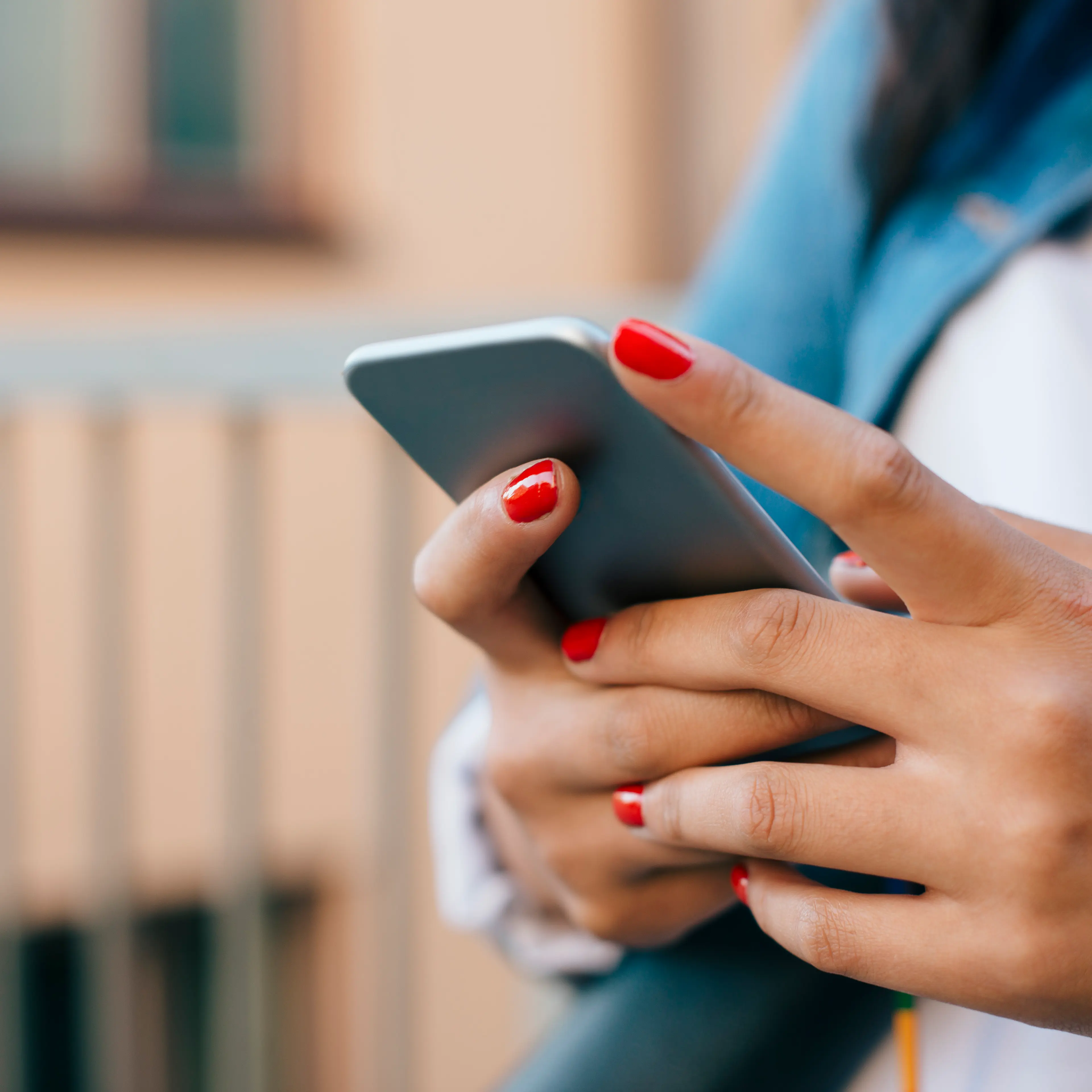 Cropped image of teenage girl using mobile phone