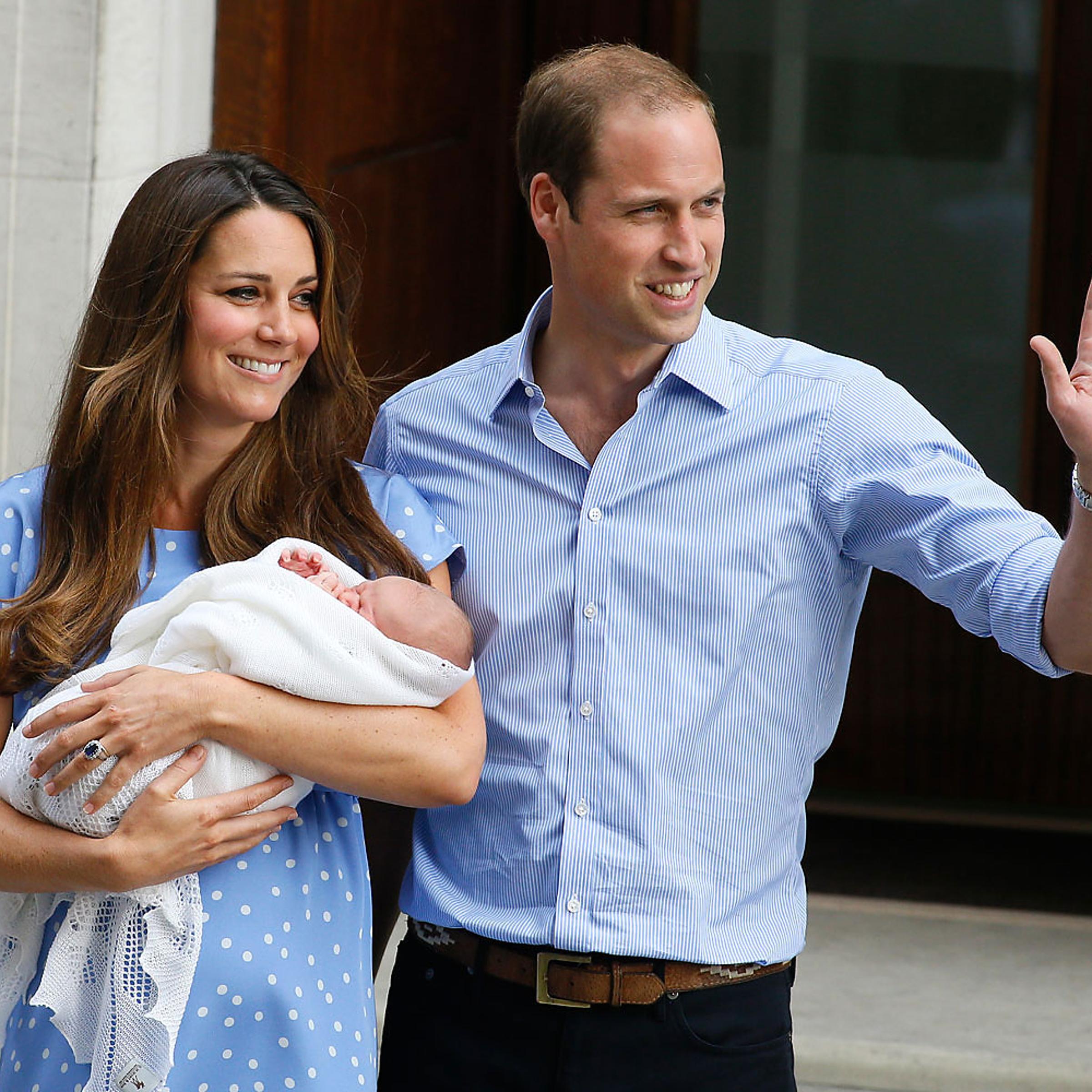 Prince William, right, and Kate, Duchess of Cambridge, hold the Prince of Cambridge, as they pose for photographers outside St. Mary's Hospital in London, July 23, 2013.
