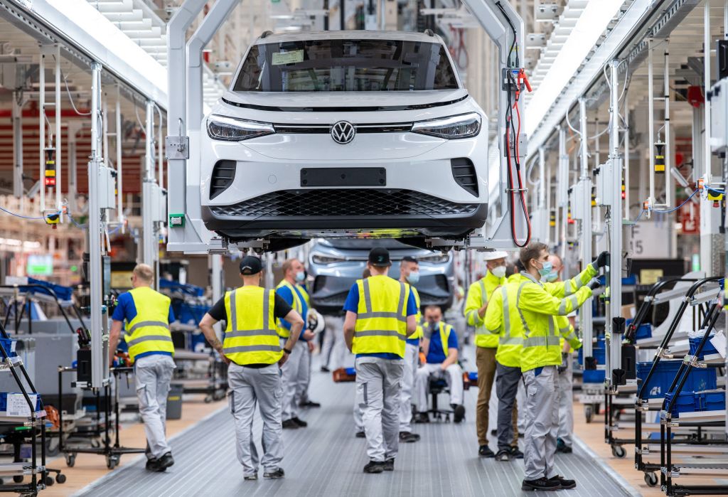 Employees work at the assembly line for the Volkswagen (VW) ID 4 electric car in the production site of Emden, northern Germany, on May 20, 2022.