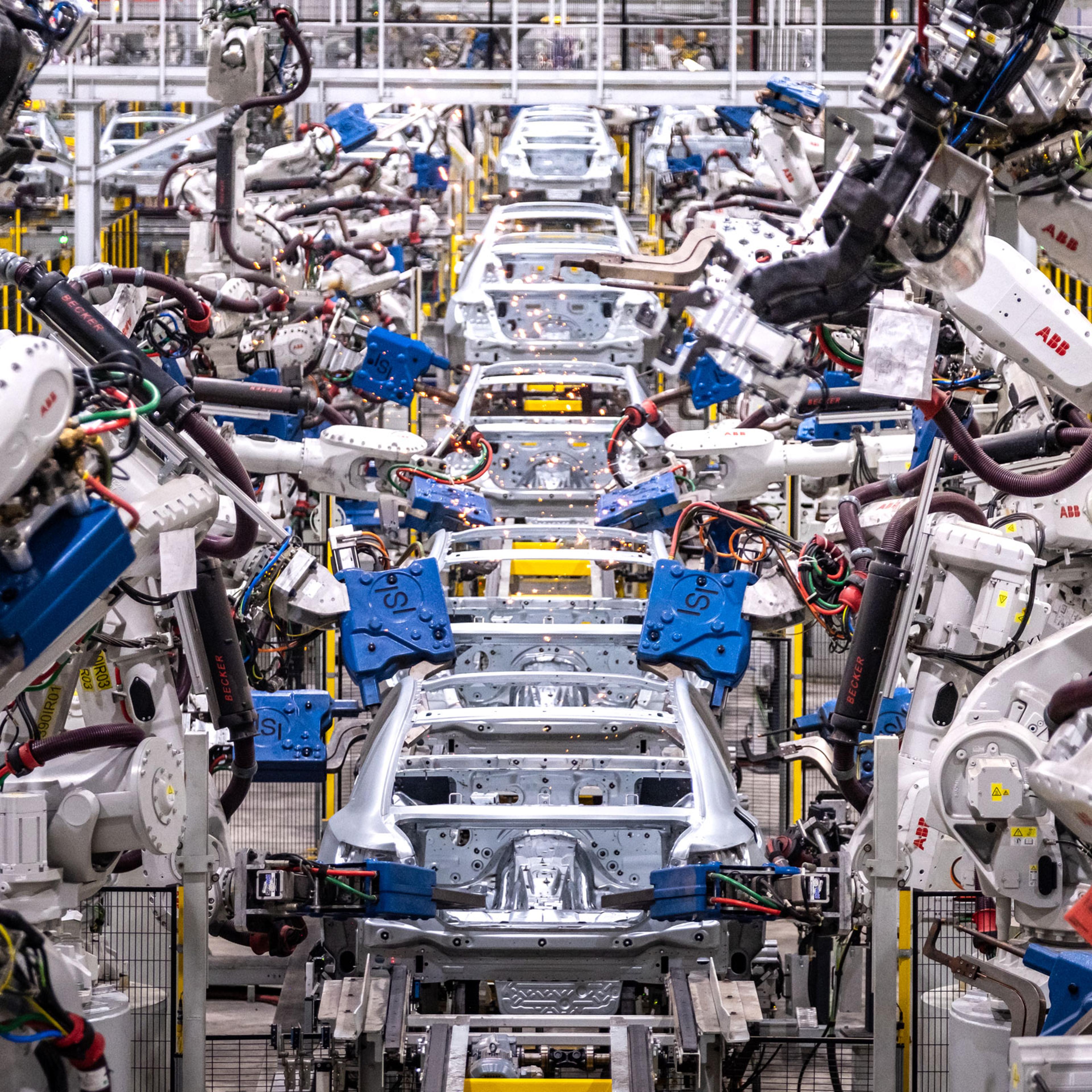 Assembly robots put together car bodies in the body shop at VinFast manufacturing plant in Haiphong, Vietnam