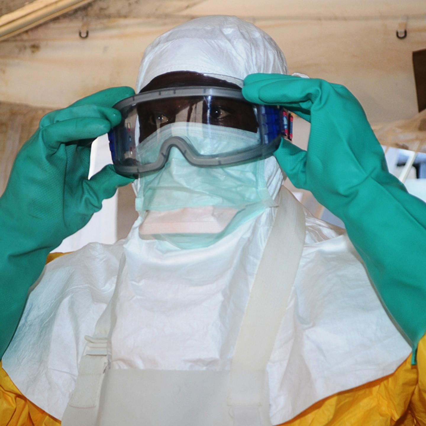 A member of Doctors Without Borders puts on protective gear in a Conakry hospital on Conakry, Guinea on June 28, 2013.