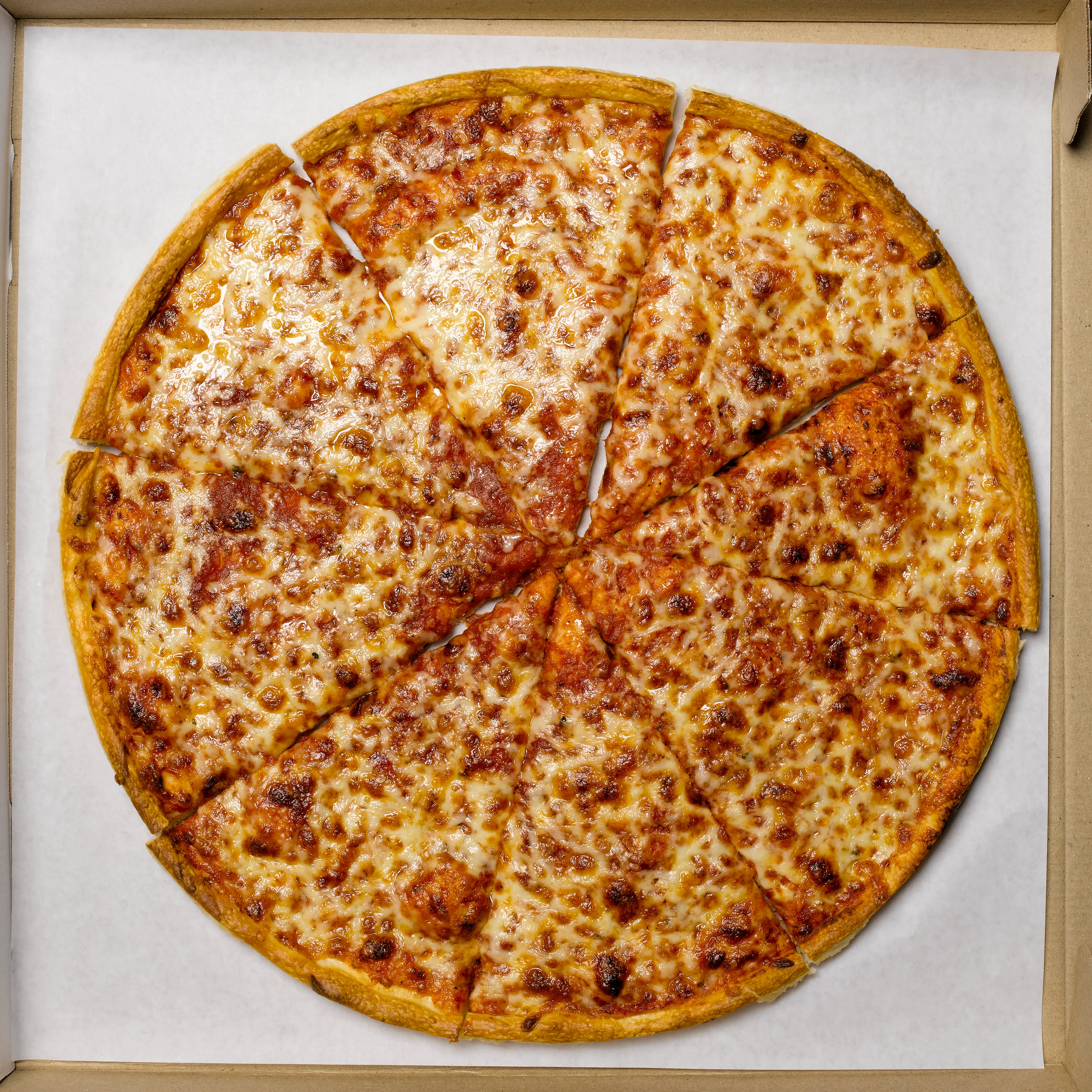 Whole pizza in box, overhead view