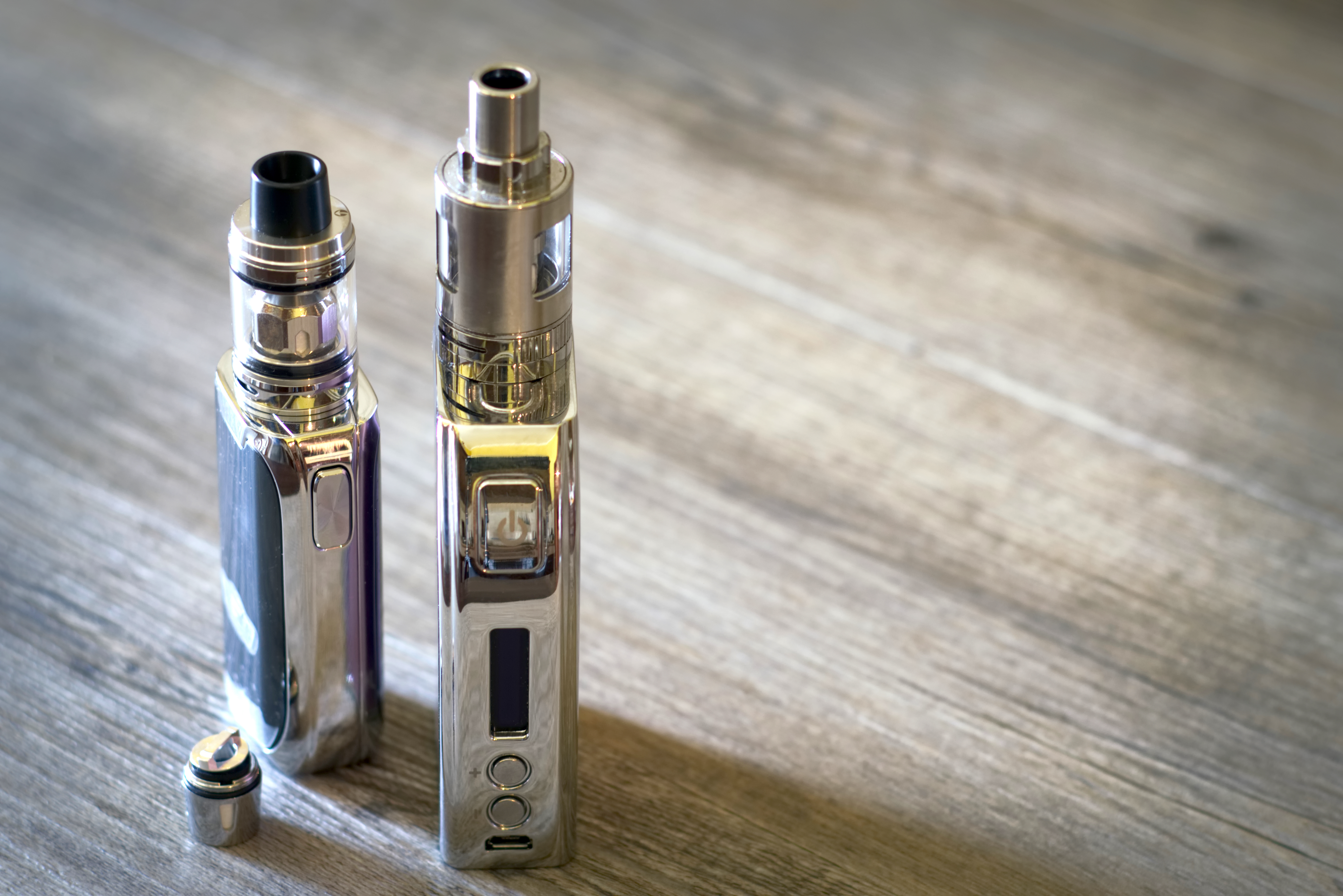 High Angle View Of Electronic Cigarette On Wooden Table