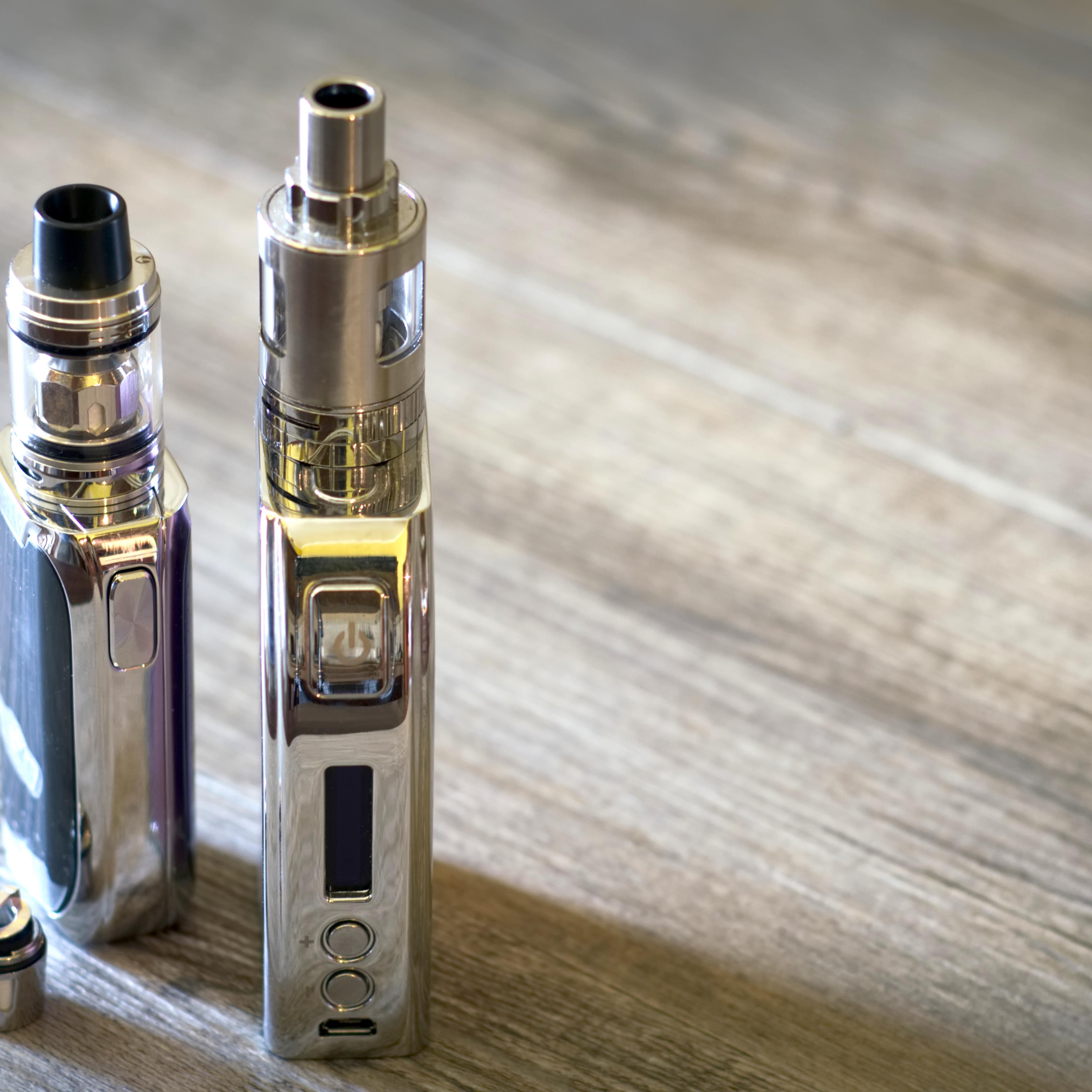 High Angle View Of Electronic Cigarette On Wooden Table