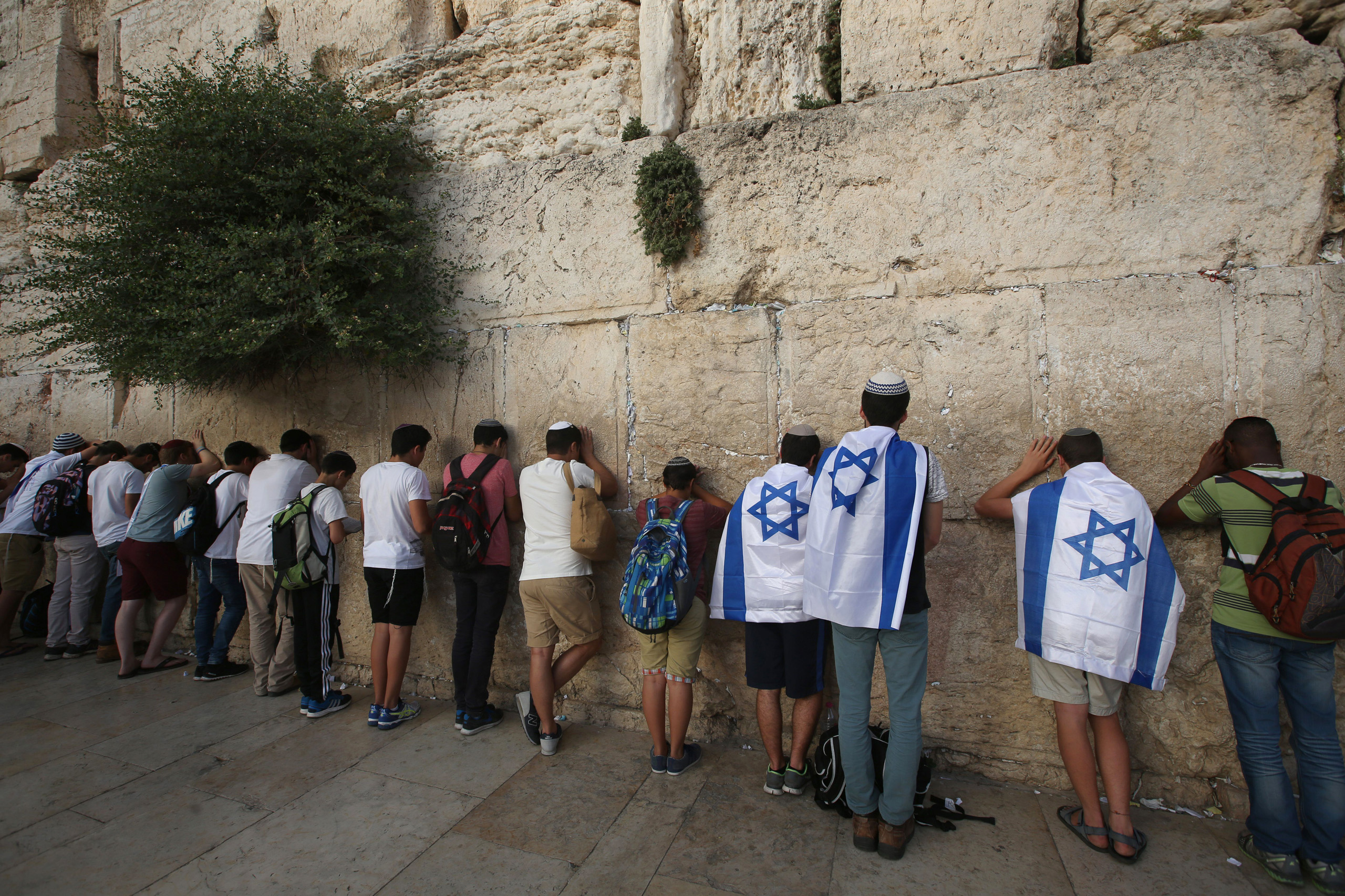 Israeli men pray at the Western Wall in Jerusalem's old city, as they celebrate Jerusalem Day, that marks the anniversary of the "reunification" of the holy city after Israel captured the Arab eastern sector from Jordan during the 1967 Six-Day War on Jun