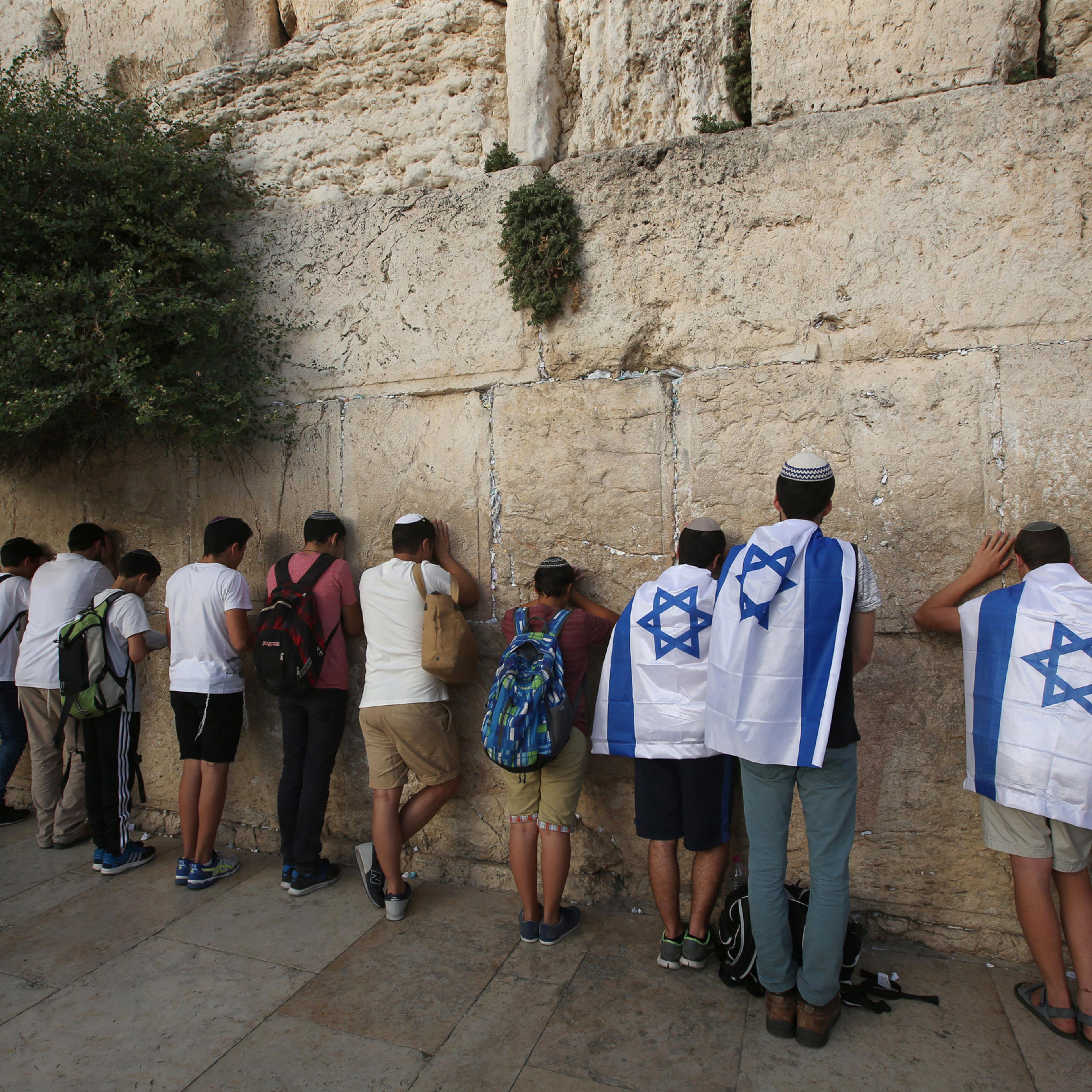 Israeli men pray at the Western Wall in Jerusalem's old city, as they celebrate Jerusalem Day, that marks the anniversary of the "reunification" of the holy city after Israel captured the Arab eastern sector from Jordan during the 1967 Six-Day War on Jun