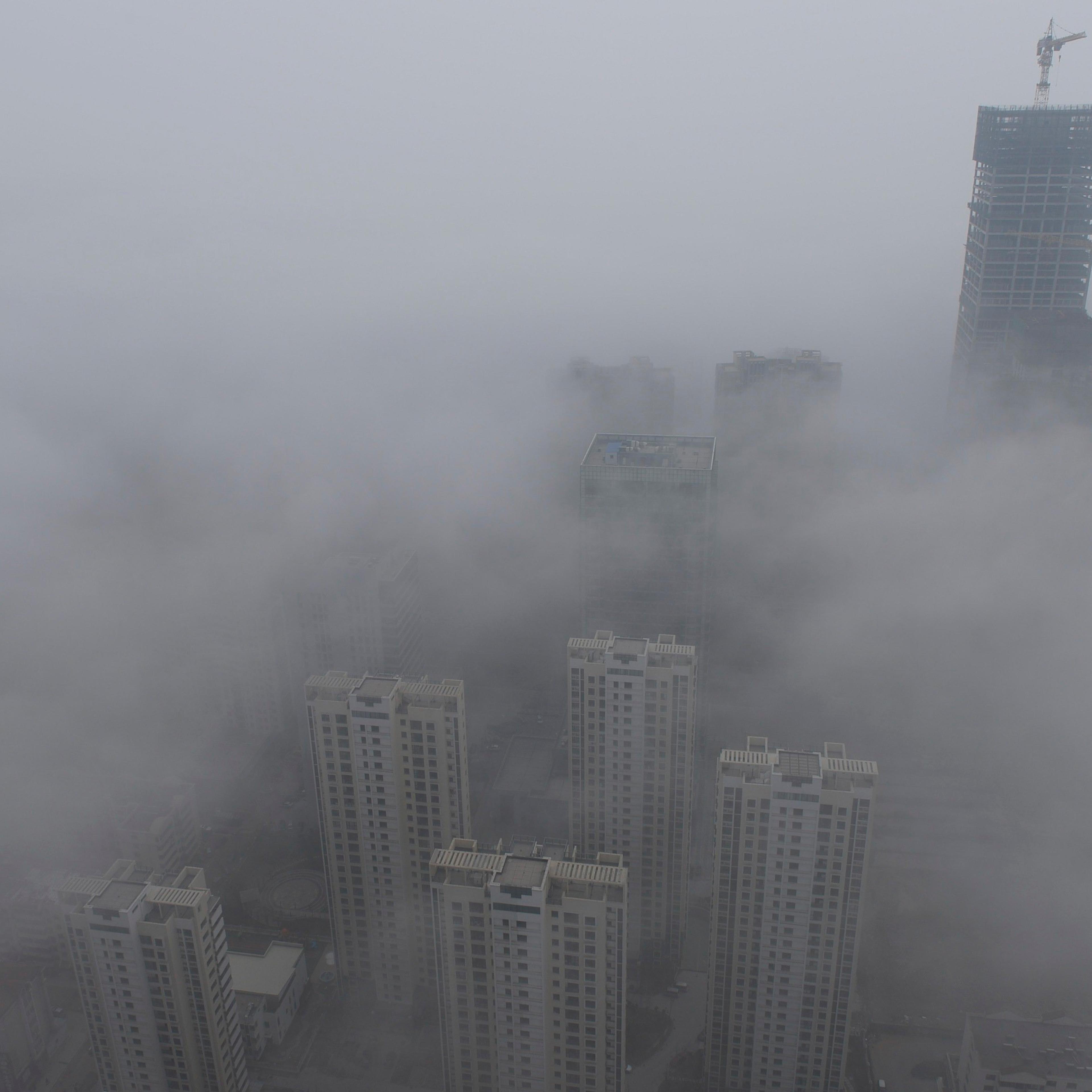 Buildings are seen shrouded in heavy haze at Qingdao development zone, Shandong province