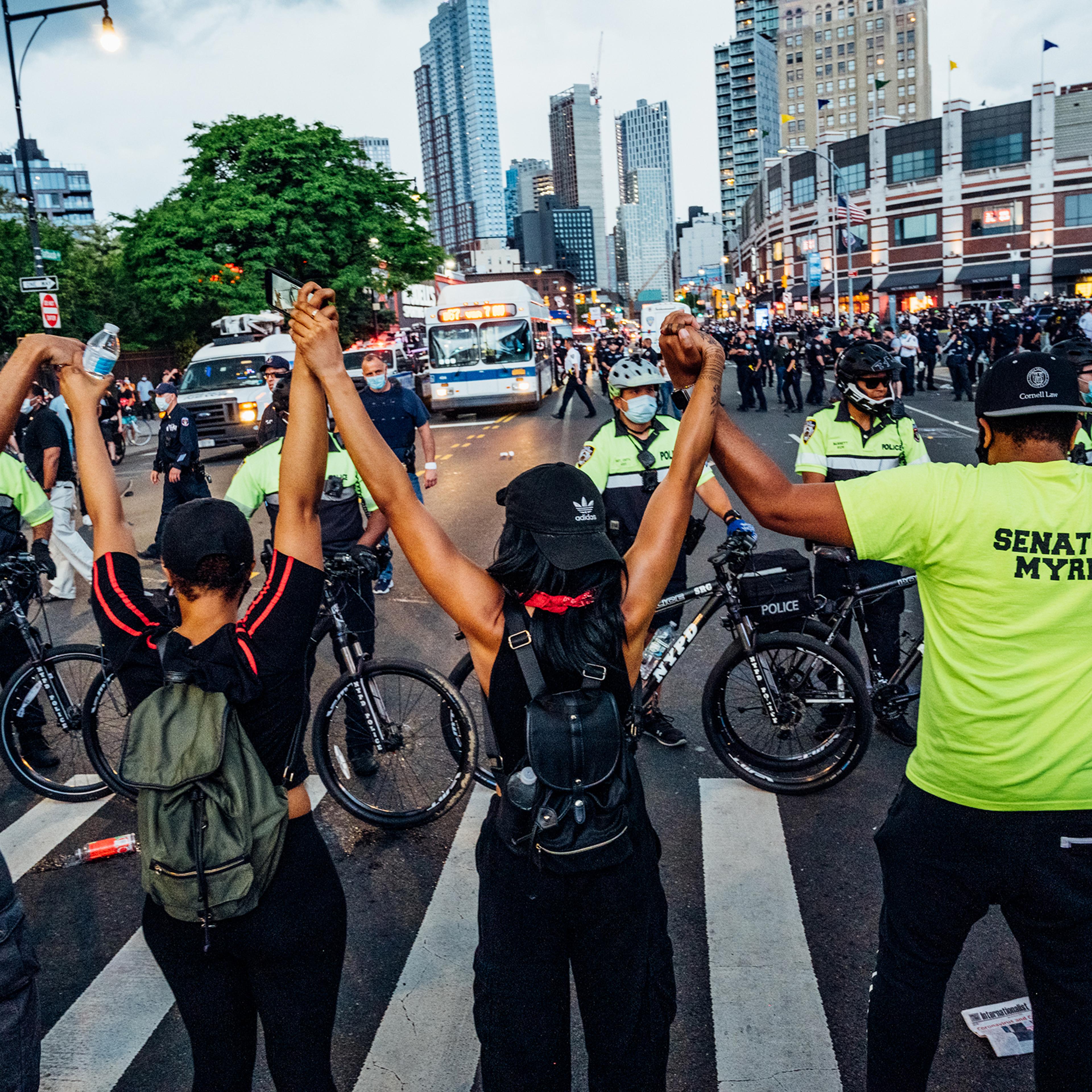 Protesters join hands while blocking an intersection near Brooklyn's Barclays Center on May 29.
