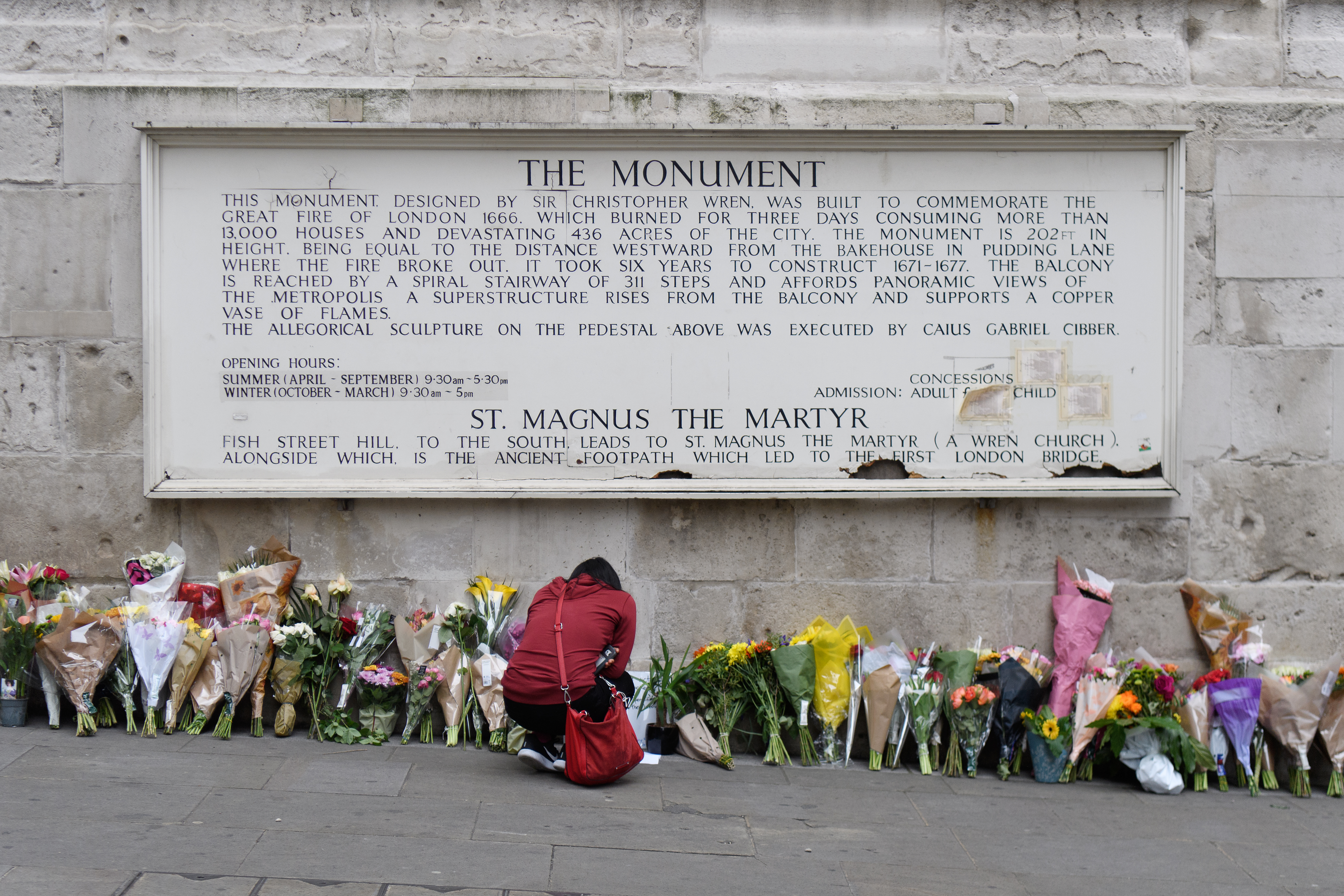 A woman looks at some of the floral tributes at Monument, near London Bridge, following the June 3rd terror attack on June 5, 2017 in London, England.