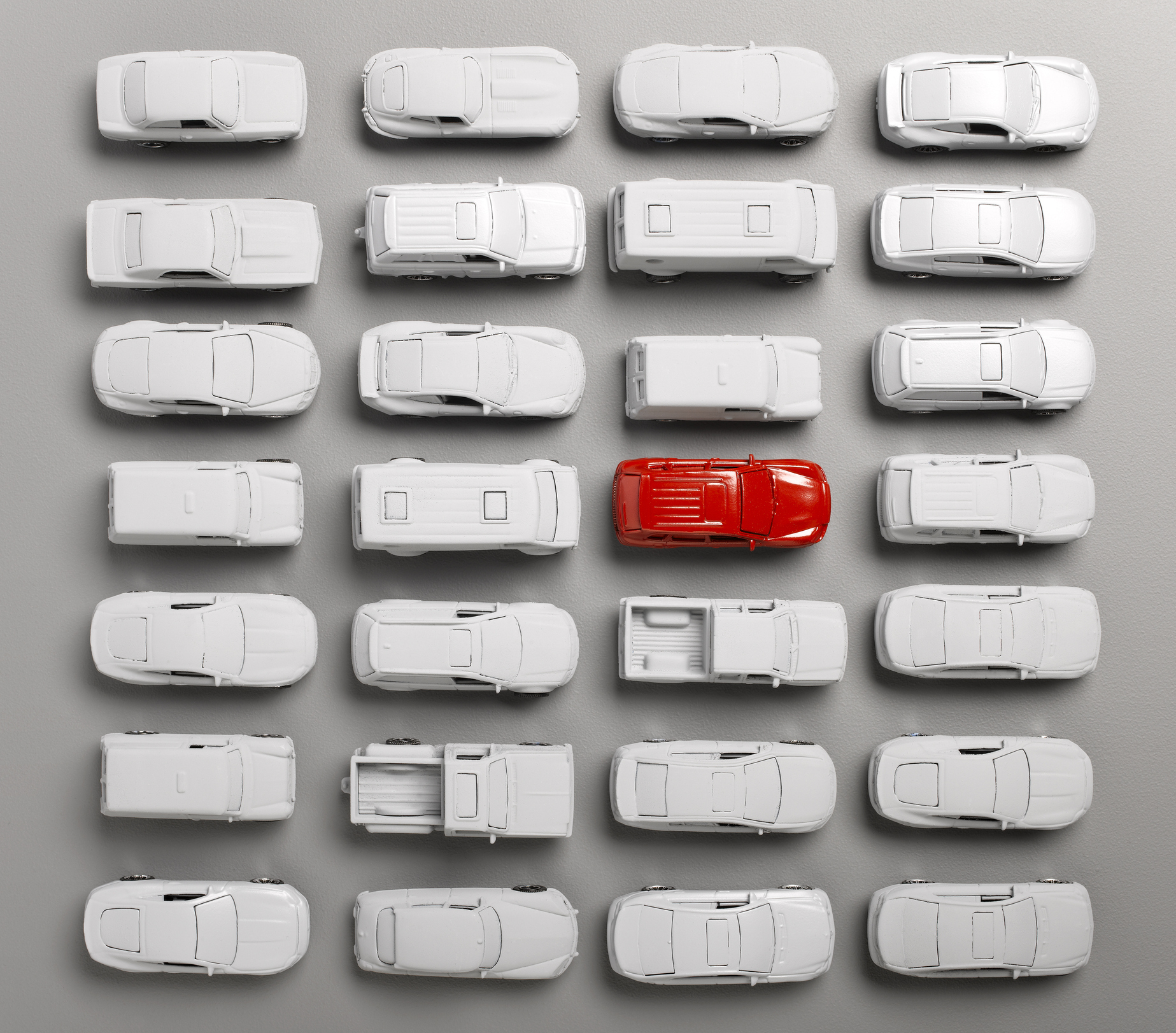 red car surounded by grey cars